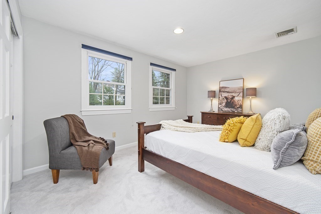 90 Ruddock Road Sudbury, MA 01776 - Photo 24 of 41 a bedroom with a bed and chair