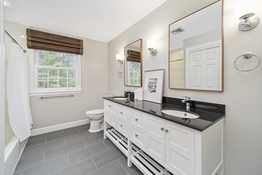 90 Ruddock Road Sudbury, MA 01776 - Photo 25 of 41 a bathroom with a granite countertop sink toilet and mirror