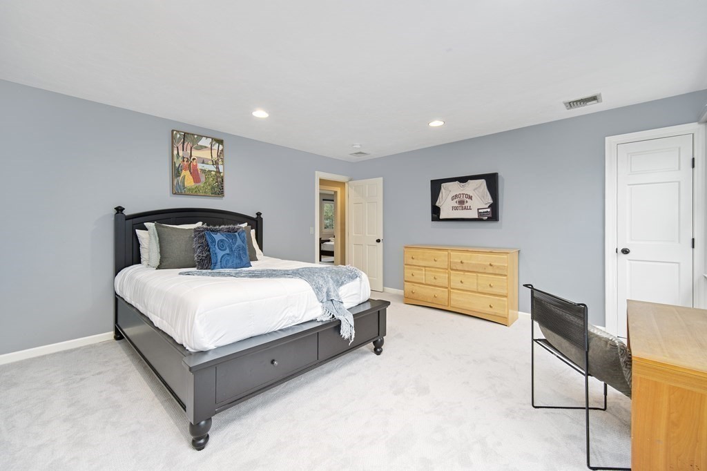 90 Ruddock Road Sudbury, MA 01776 - Photo 26 of 41 a bedroom with a bed and chair
