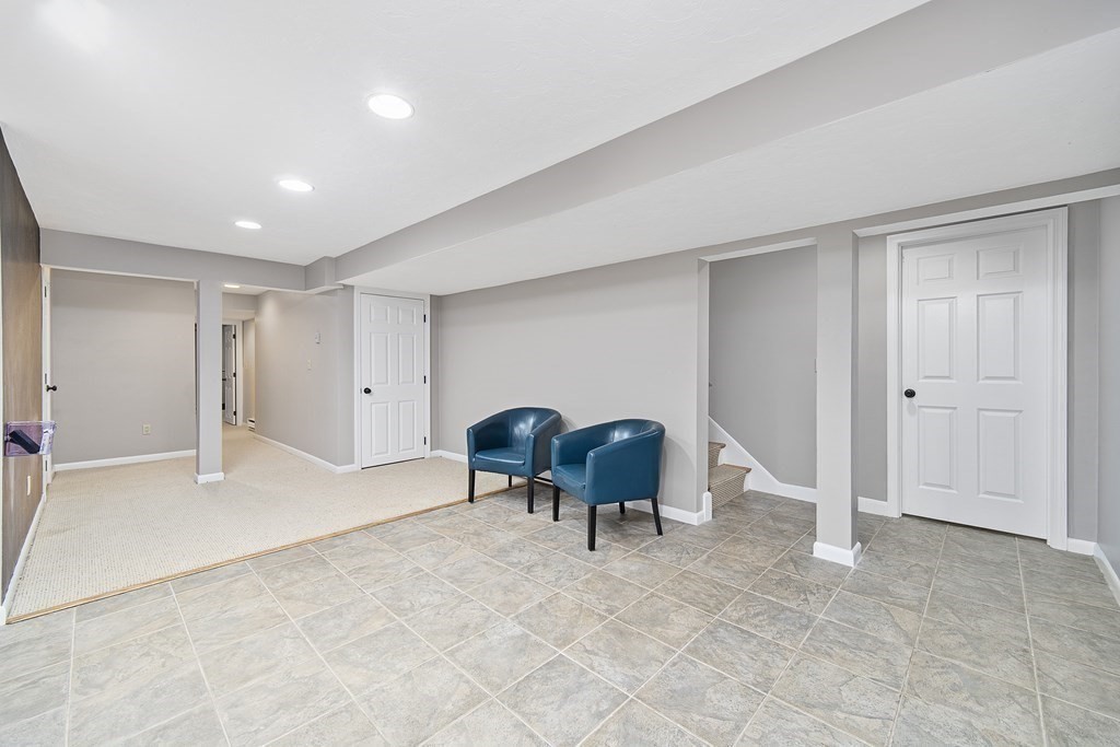 90 Ruddock Road Sudbury, MA 01776 - Photo 32 of 41 a view of a livingroom with furniture and gym equipment