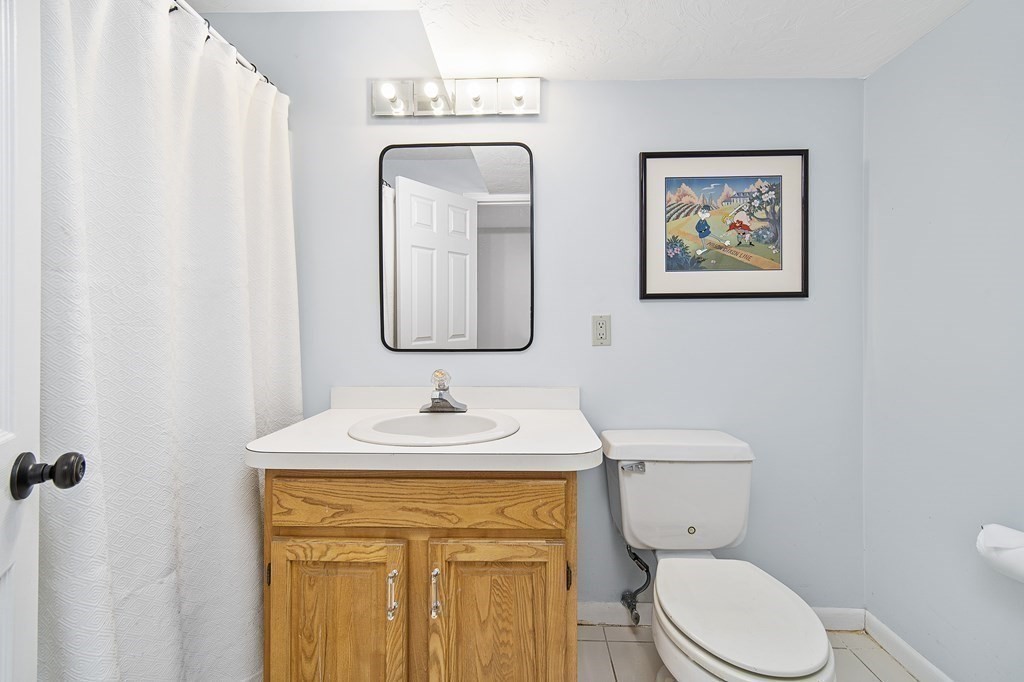 90 Ruddock Road Sudbury, MA 01776 - Photo 33 of 41 a bathroom with a toilet sink and mirror