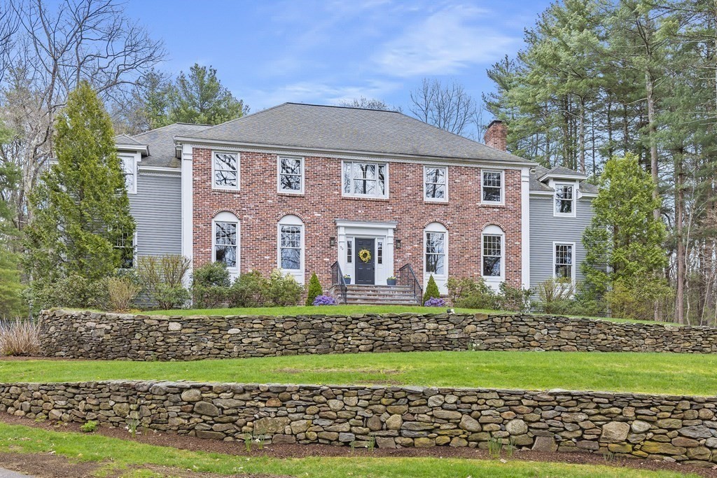 90 Ruddock Road Sudbury, MA 01776 - Photo 35 of 41 a front view of a house with a yard