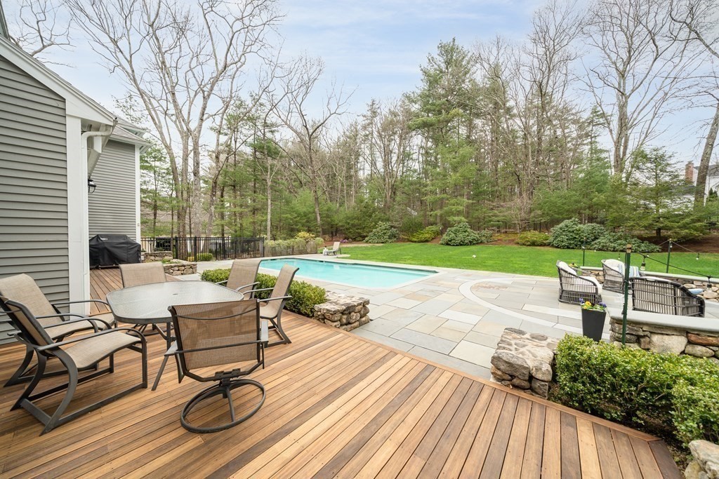 90 Ruddock Road Sudbury, MA 01776 - Photo 37 of 41 a view of a patio with table and chairs and wooden floor