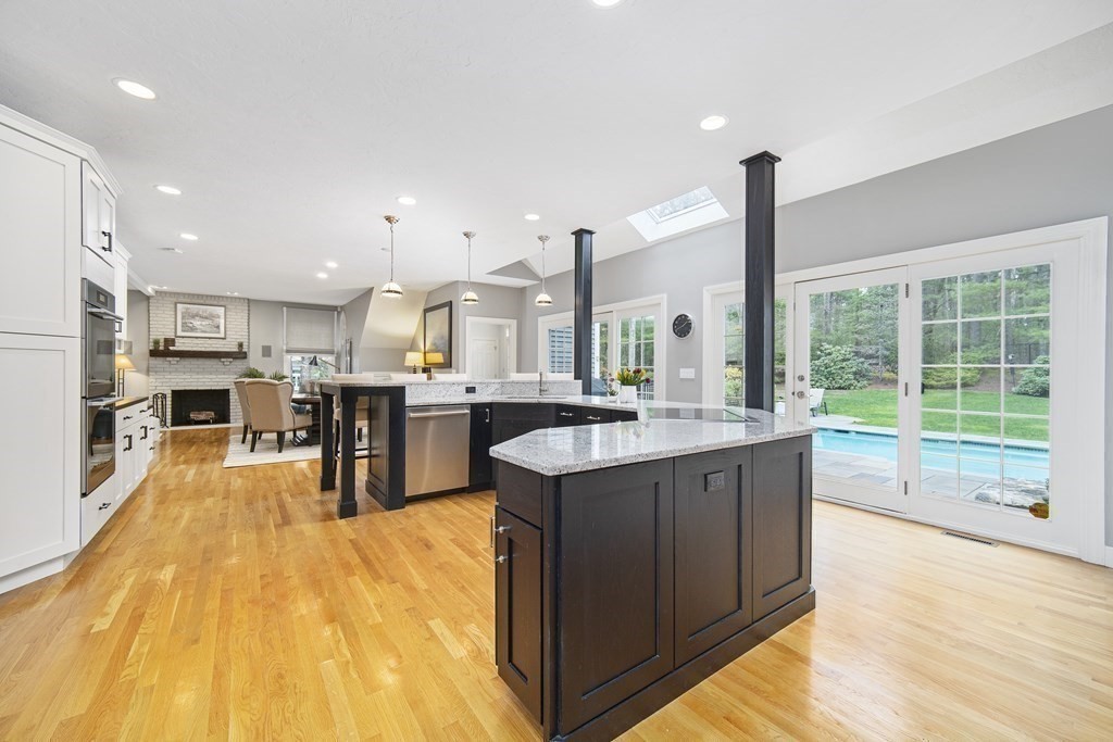90 Ruddock Road Sudbury, MA 01776 - Photo 6 of 41 a kitchen with stainless steel appliances granite countertop wooden floors a sink and a counter top space