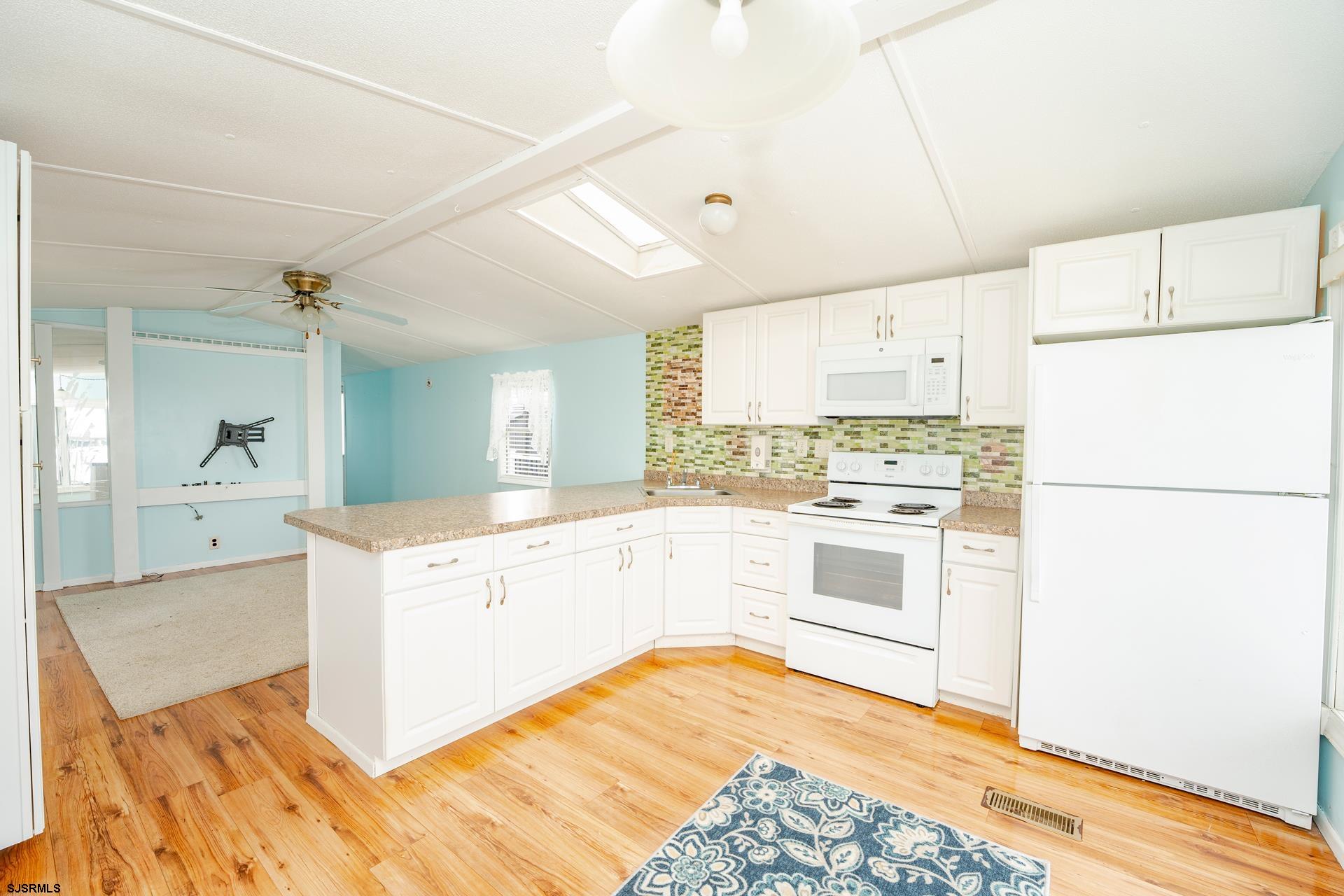 1810 Somers Point Road Egg Harbor Township, NJ 08234 - Photo 11 of 25 a kitchen with granite countertop white cabinets and white appliances