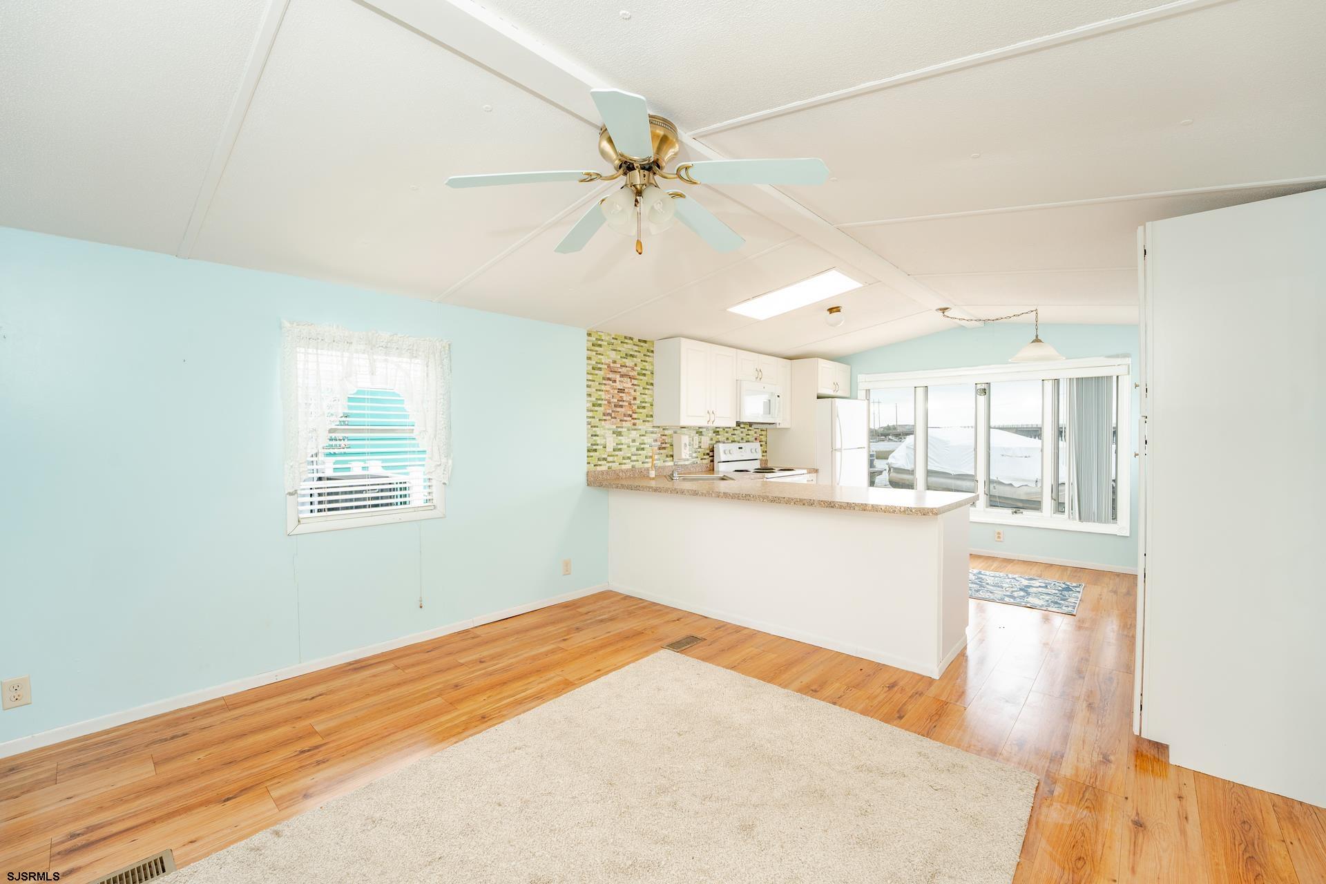 1810 Somers Point Road Egg Harbor Township, NJ 08234 - Photo 8 of 25 a view of a kitchen with wooden floor and a ceiling fan