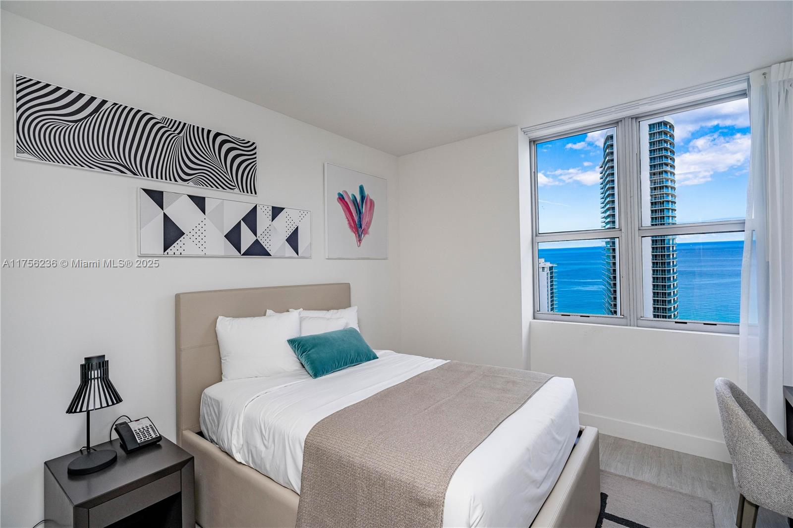 4010 South Ocean Drive, Unit R1609 Hollywood, FL 33019 - Photo 13 of 50 a bedroom with a bed and a window