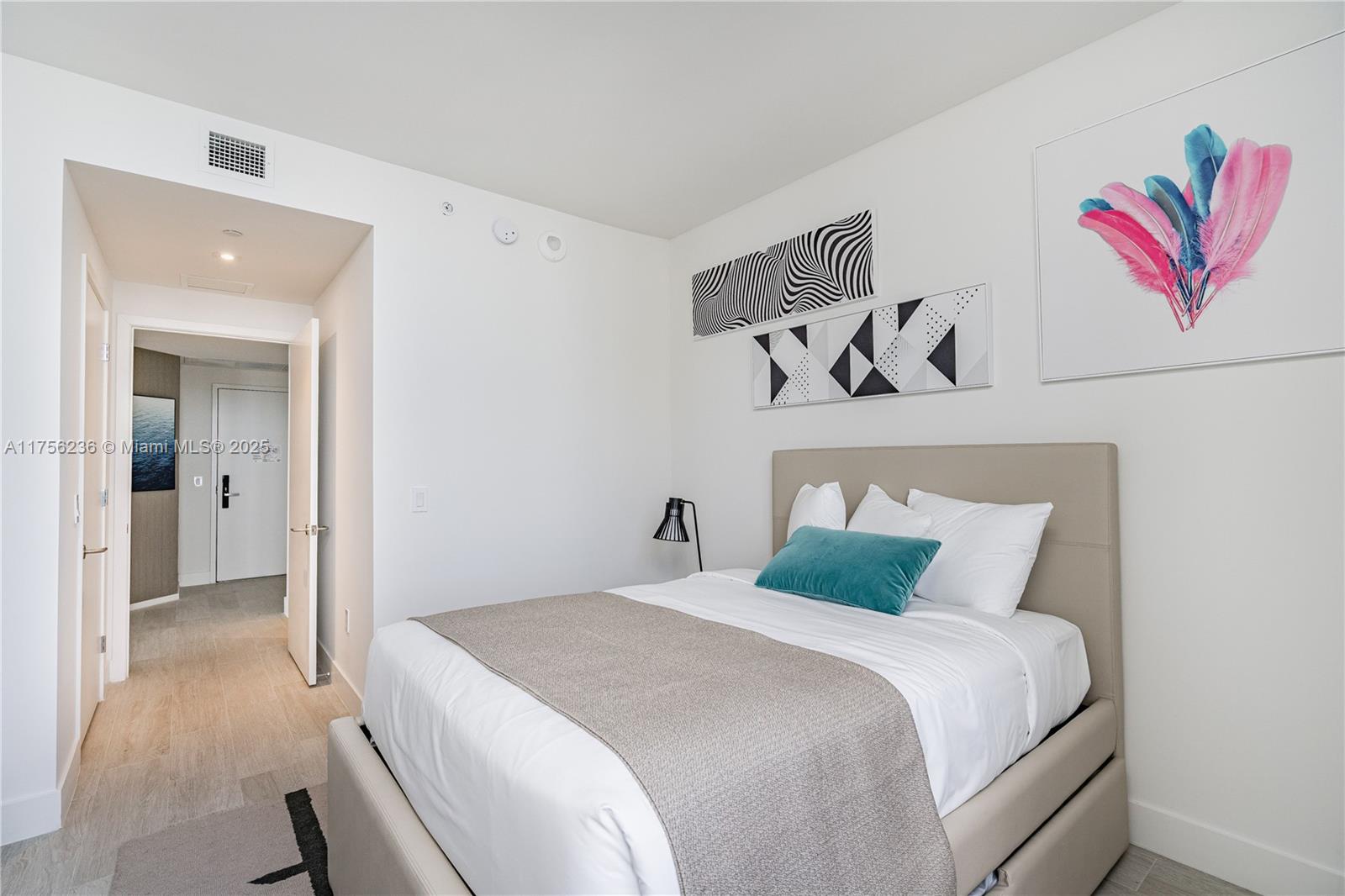 4010 South Ocean Drive, Unit R1609 Hollywood, FL 33019 - Photo 14 of 50 a bedroom with a bed and painting on the wall