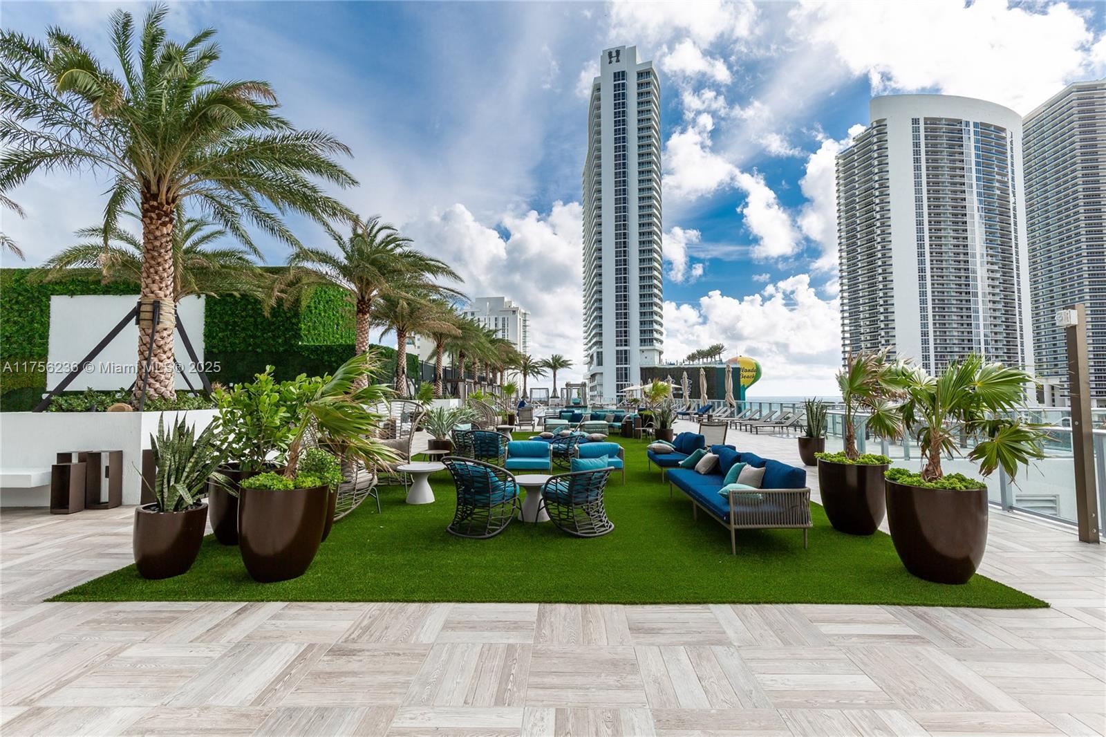 4010 South Ocean Drive, Unit R1609 Hollywood, FL 33019 - Photo 34 of 50 a front view of a multi story building with yard and car parked