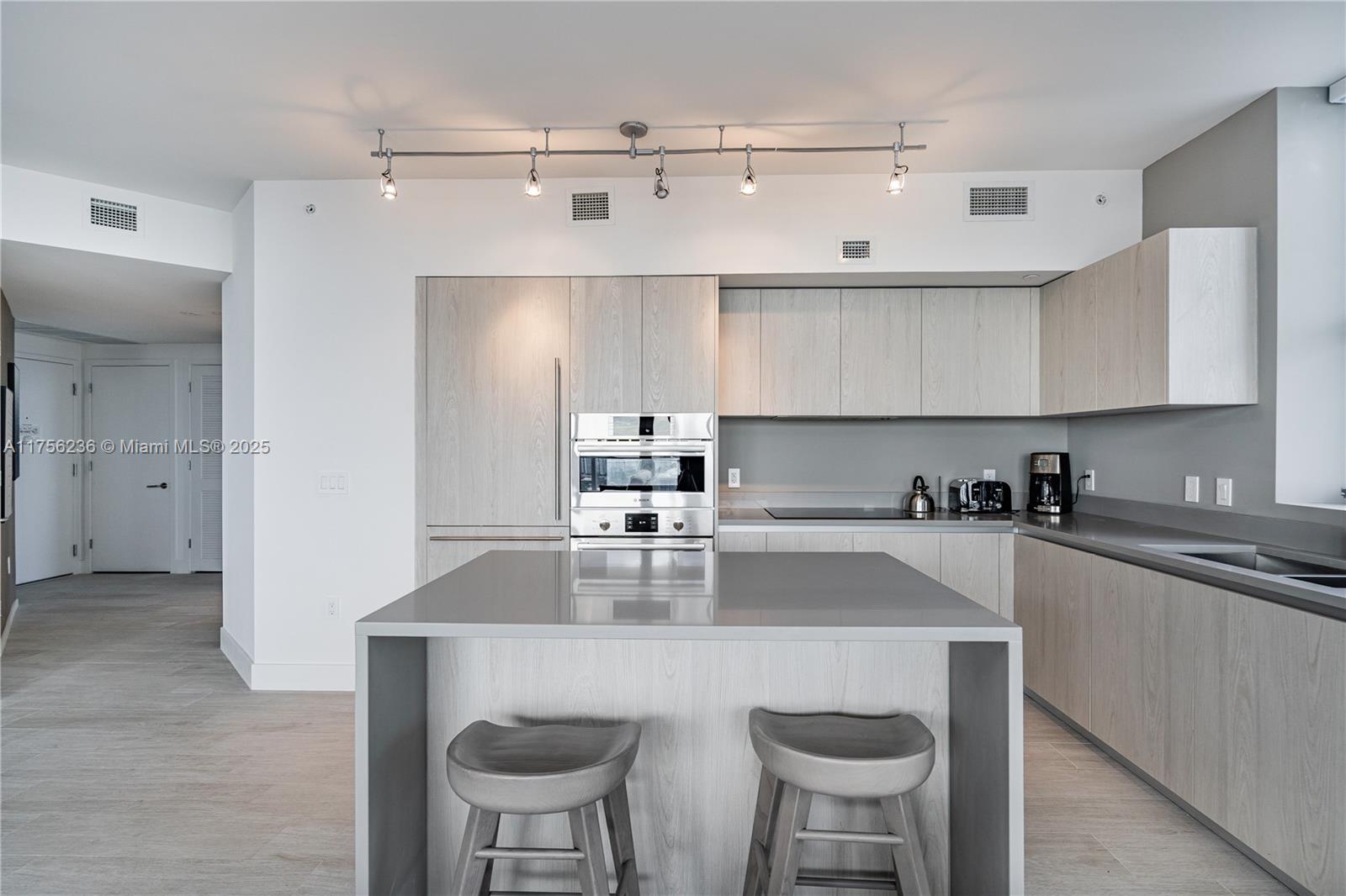 4010 South Ocean Drive, Unit R1609 Hollywood, FL 33019 - Photo 10 of 50 a kitchen with kitchen island a sink stove and refrigerator