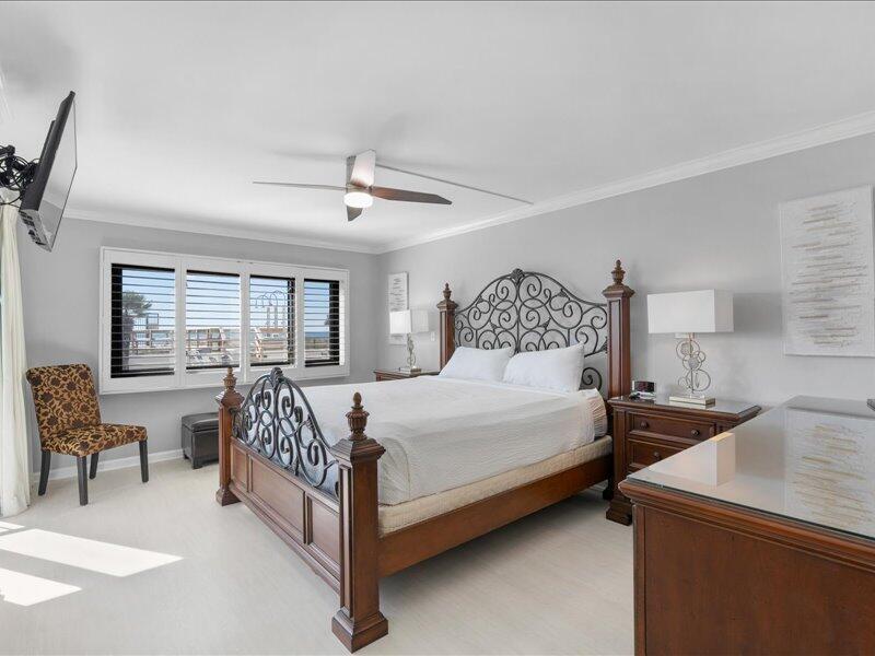 1044 Highway 98, Unit 101 Destin, FL 32541 - Photo 15 of 29 a bedroom with a bed and a chair