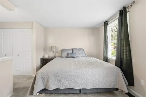 a bedroom with a bed and window