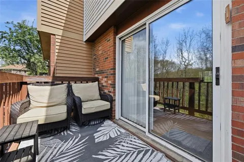 a view of a balcony with furniture
