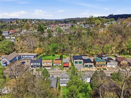 an aerial view of a house with a lake view