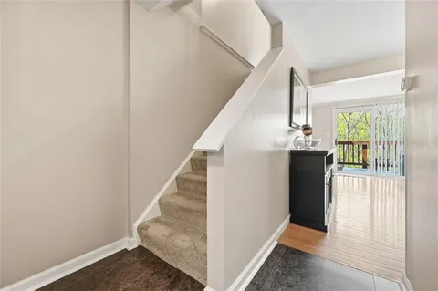 a view of entryway and hall with wooden floor