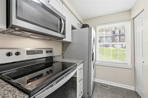 a kitchen with a stove and a microwave