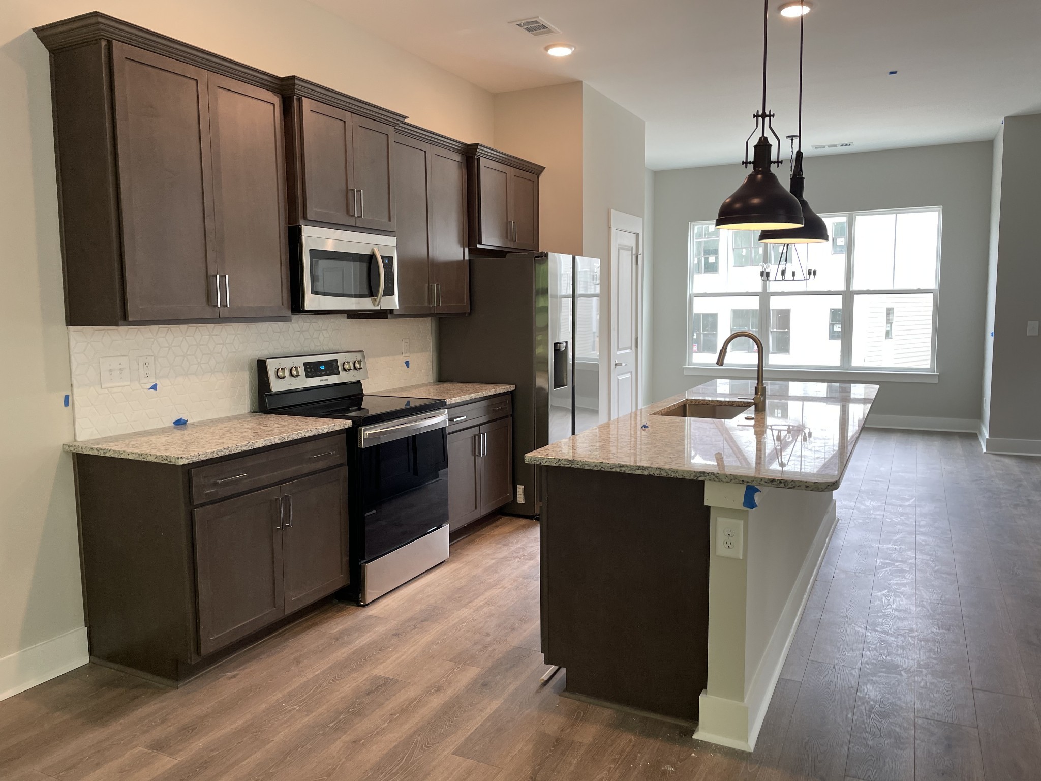 217 Stonecrest Drive, Unit 217 Nashville, TN 37209 - Photo 4 of 20 a kitchen with stainless steel appliances a sink stove and refrigerator