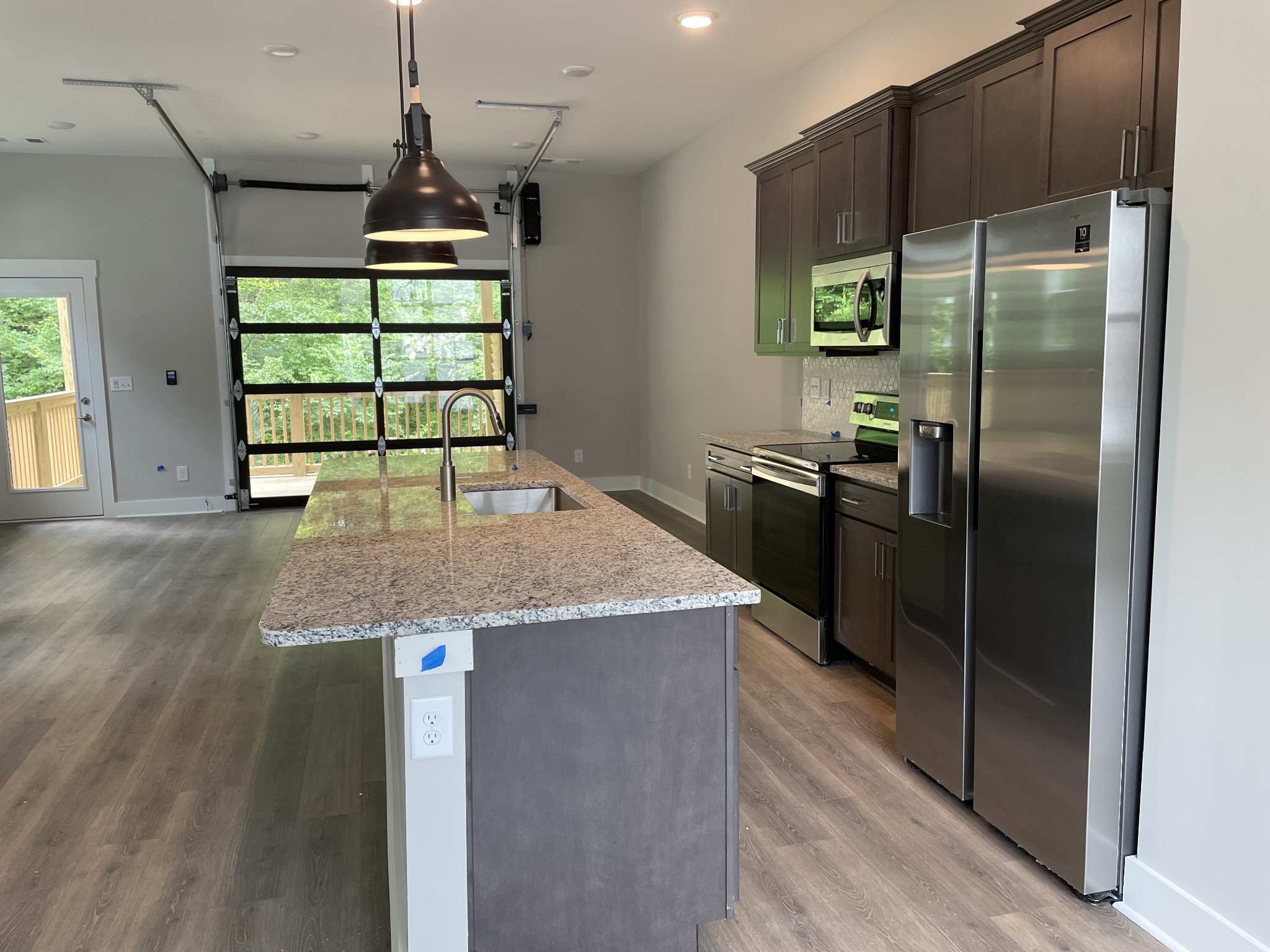 217 Stonecrest Drive, Unit 217 Nashville, TN 37209 - Photo 5 of 20 a kitchen with kitchen island a counter top space cabinets and stainless steel appliances