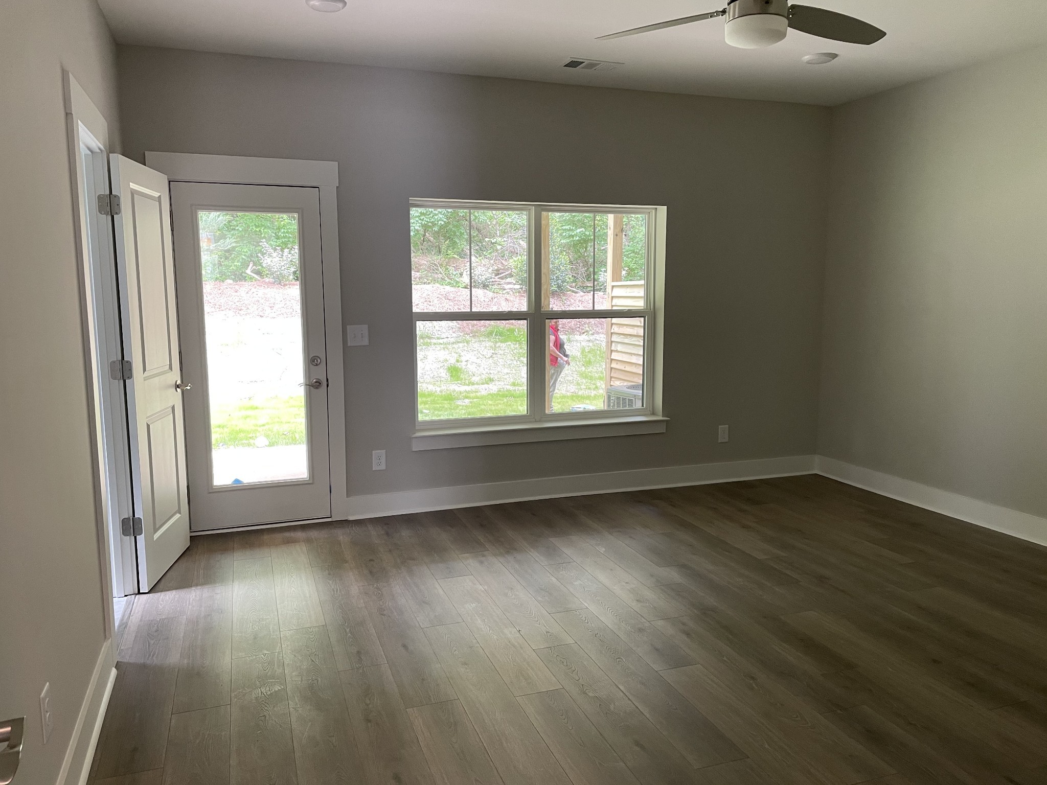 217 Stonecrest Drive, Unit 217 Nashville, TN 37209 - Photo 6 of 20 a view of an empty room with wooden floor and a window
