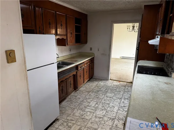 a kitchen with stainless steel appliances granite countertop a refrigerator and a stove