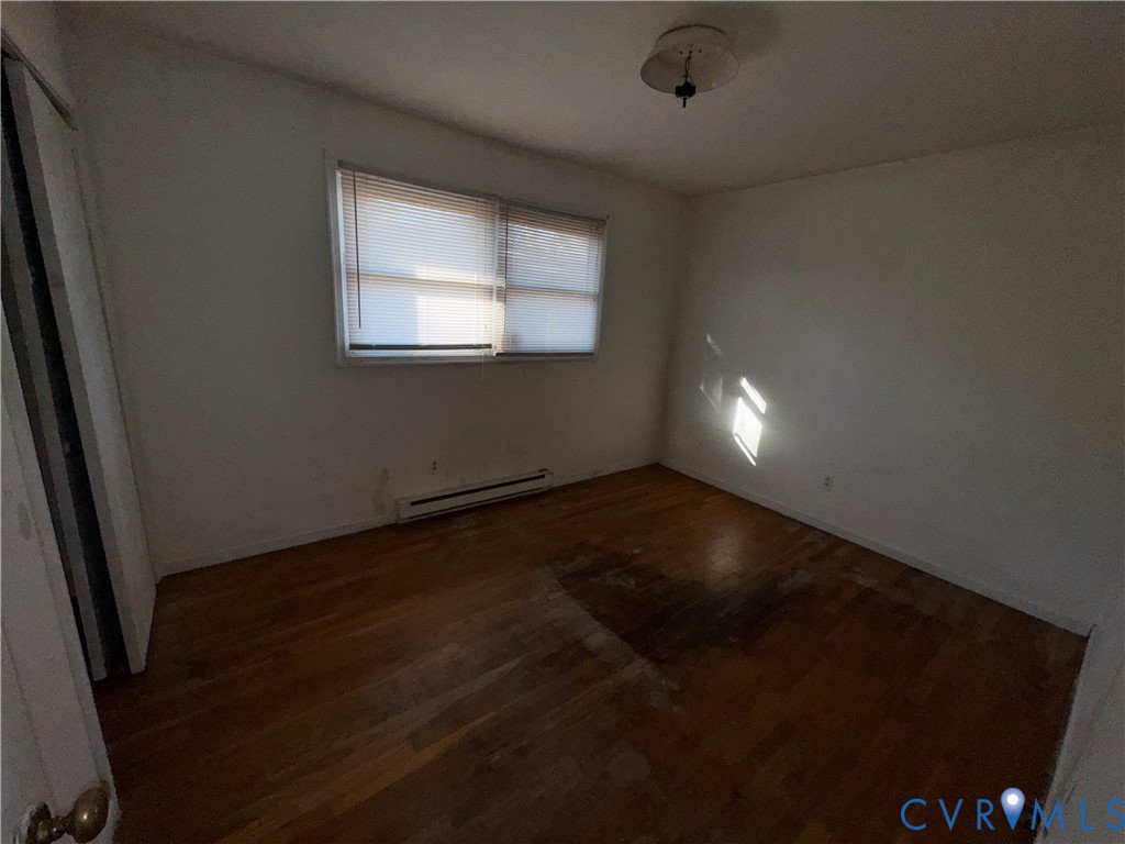 3343 Union Branch Road Petersburg, VA 23805 - Photo 8 of 11 a view of an empty room with wooden floor and a window