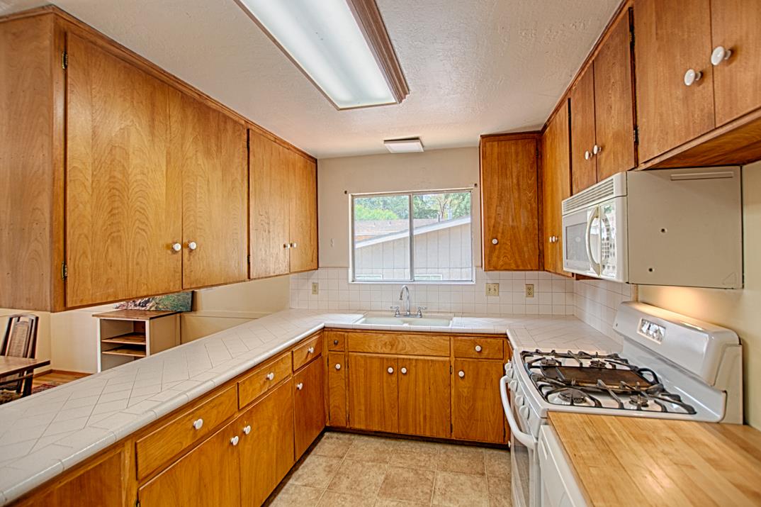 7 Plaza Mount Hermon, CA 95041 - Photo 13 of 26 a kitchen with sink a stove and cabinets