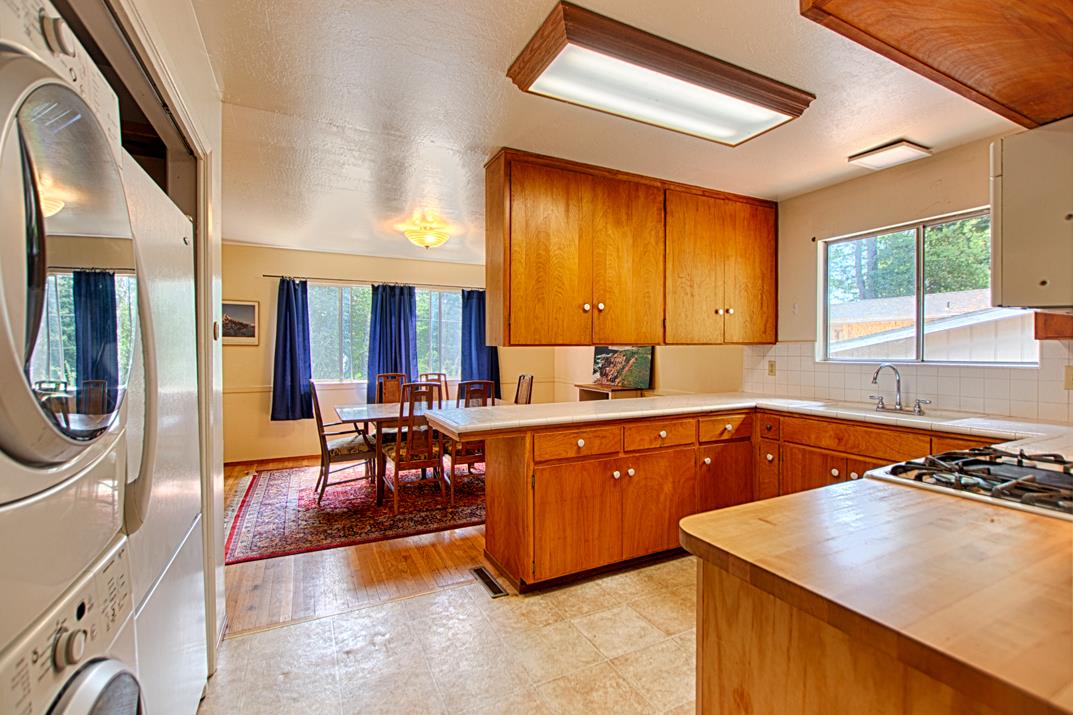 7 Plaza Mount Hermon, CA 95041 - Photo 15 of 26 a kitchen with wooden cabinets a sink a stove and a window