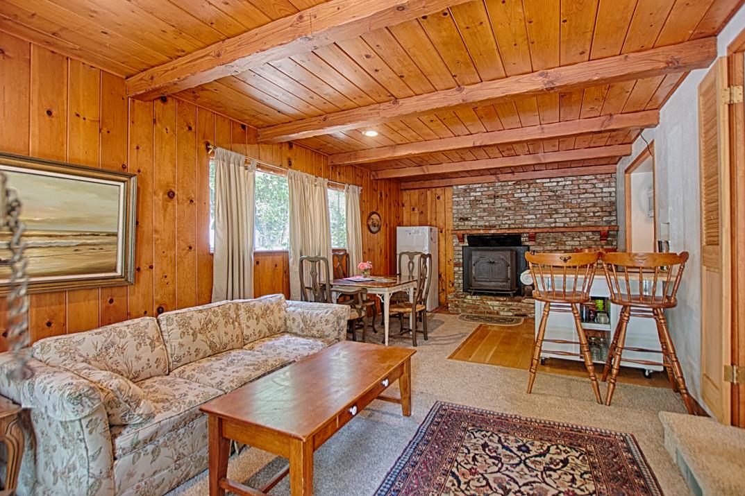 7 Plaza Mount Hermon, CA 95041 - Photo 22 of 26 a living room with furniture a fireplace and a table