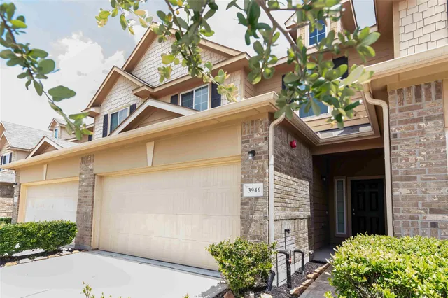 a view of a house with a flower garden