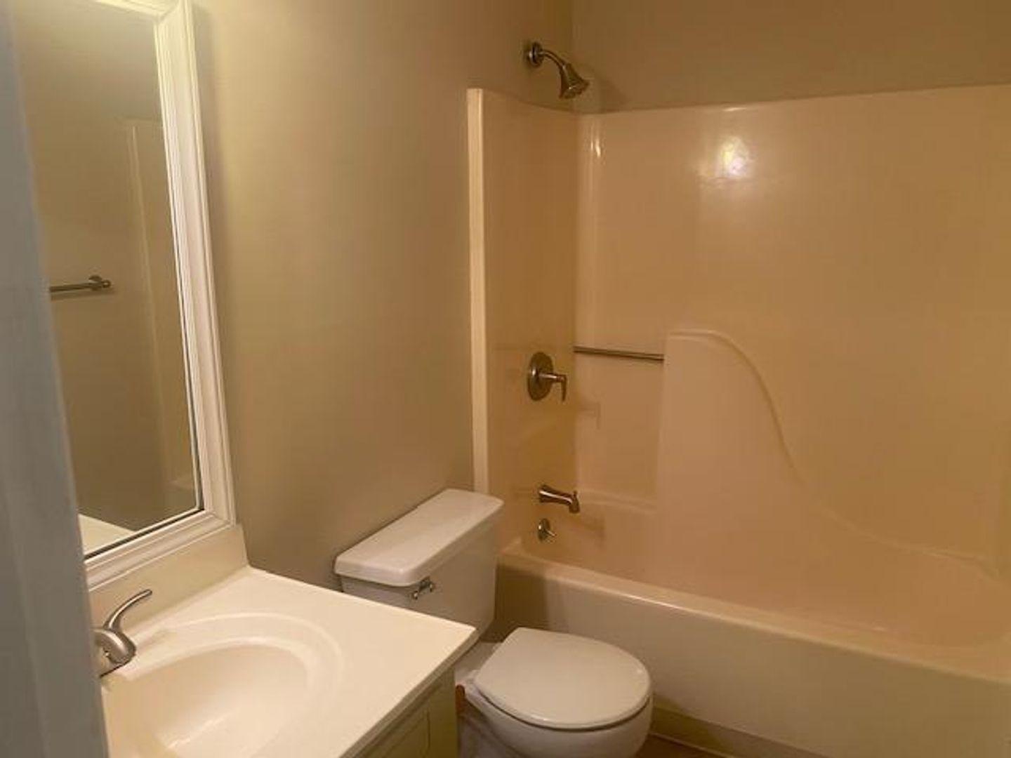 1917 Carthage Circle Raleigh, NC 27604 - Photo 14 of 15 a white toilet sitting next to a bath tub