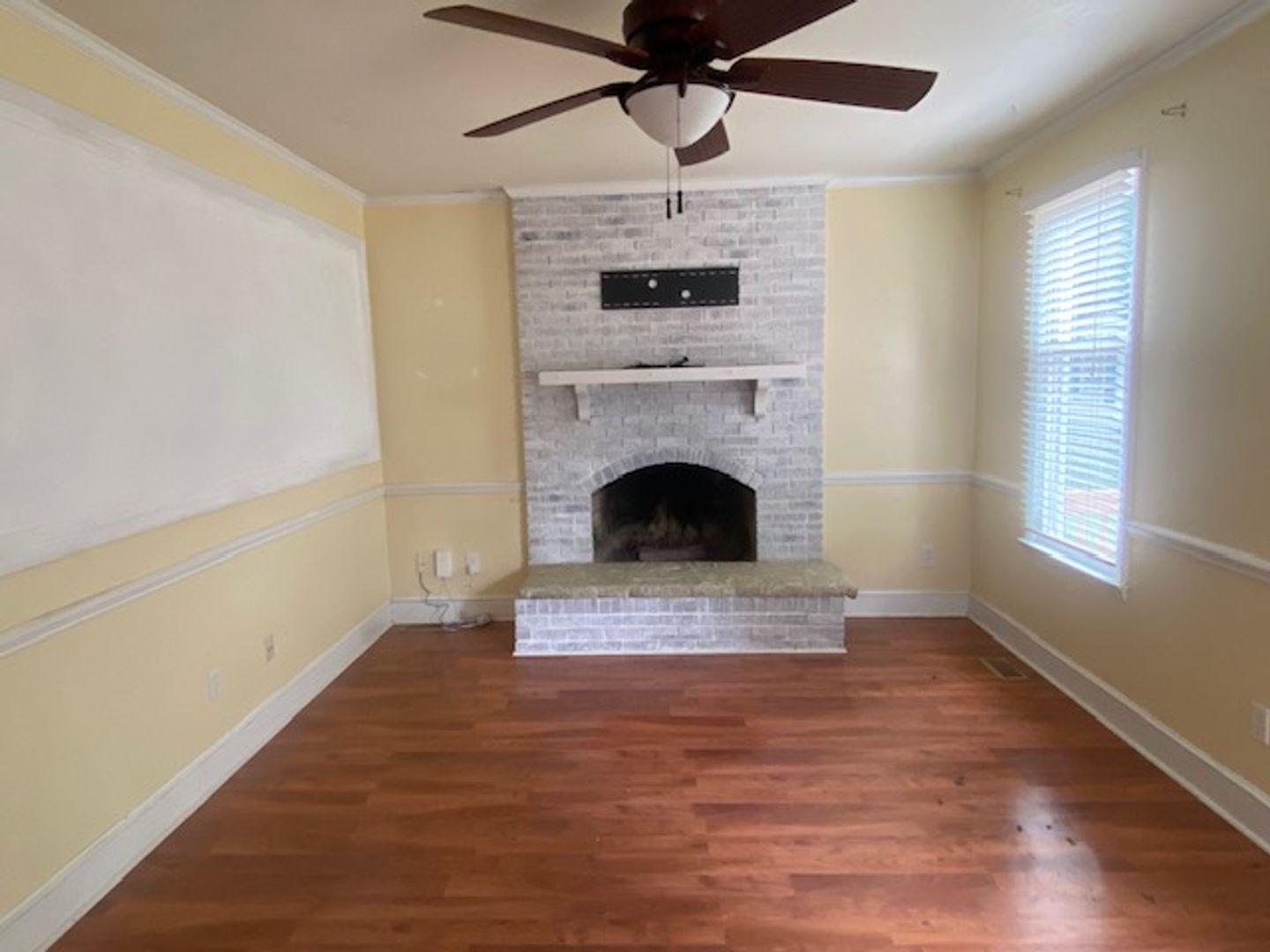 1917 Carthage Circle Raleigh, NC 27604 - Photo 3 of 15 a view of empty room with fireplace and wooden floor