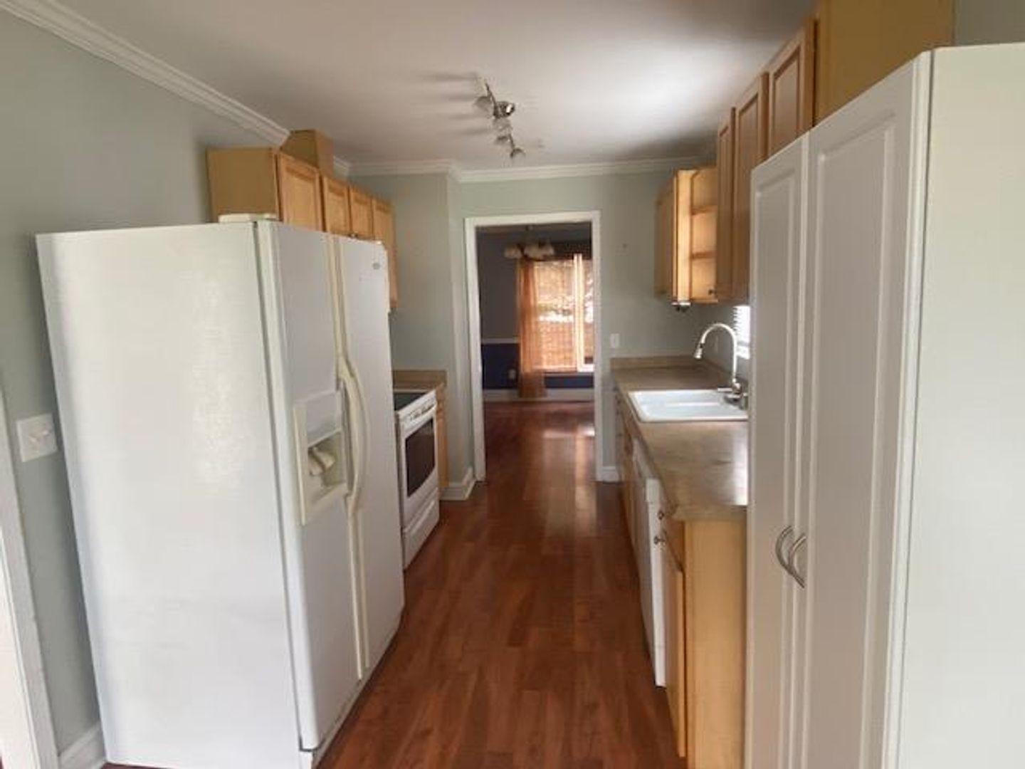 1917 Carthage Circle Raleigh, NC 27604 - Photo 5 of 15 a kitchen with stainless steel appliances a refrigerator and wooden floor