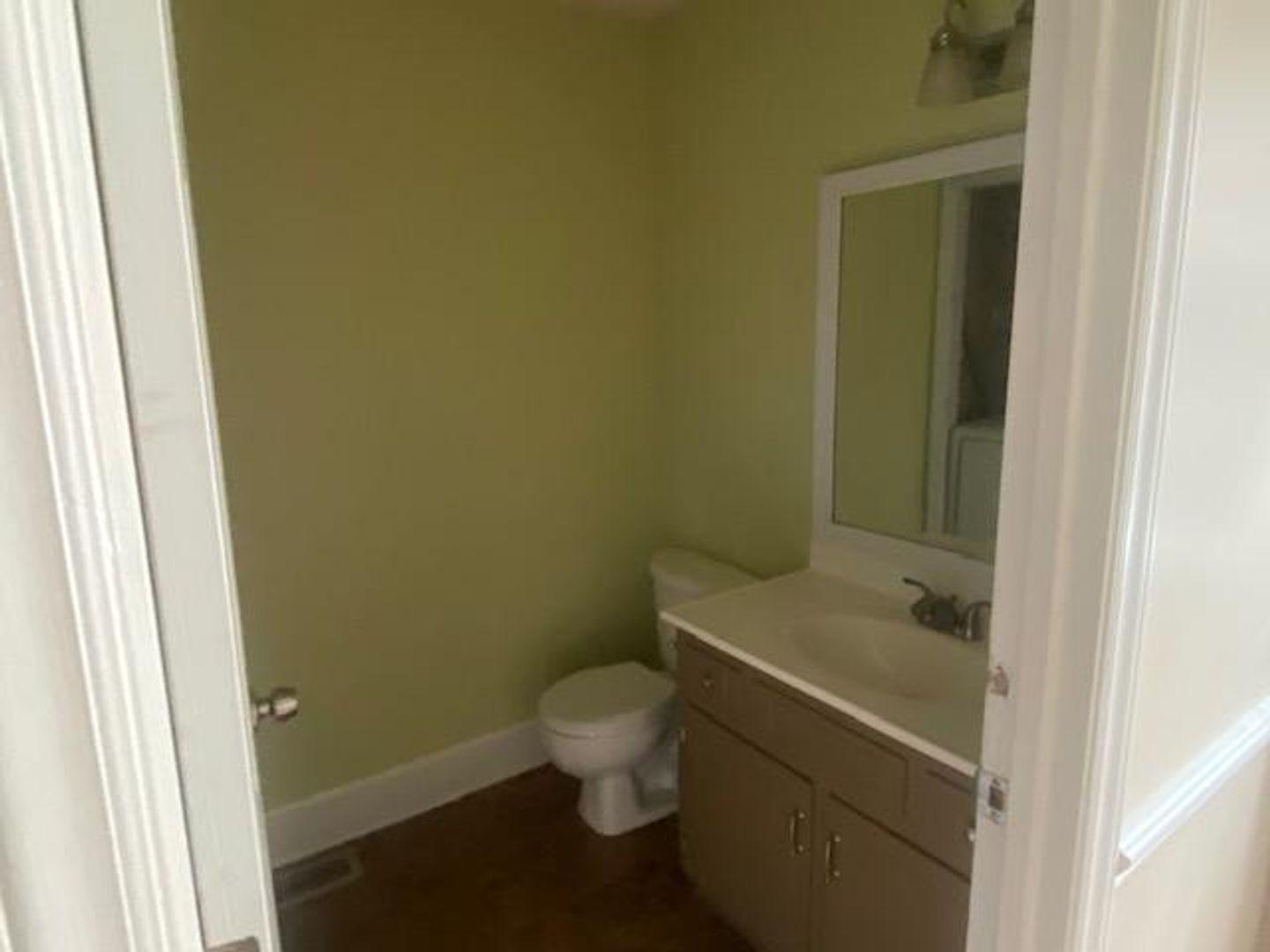 1917 Carthage Circle Raleigh, NC 27604 - Photo 7 of 15 a bathroom with a granite countertop toilet and a sink