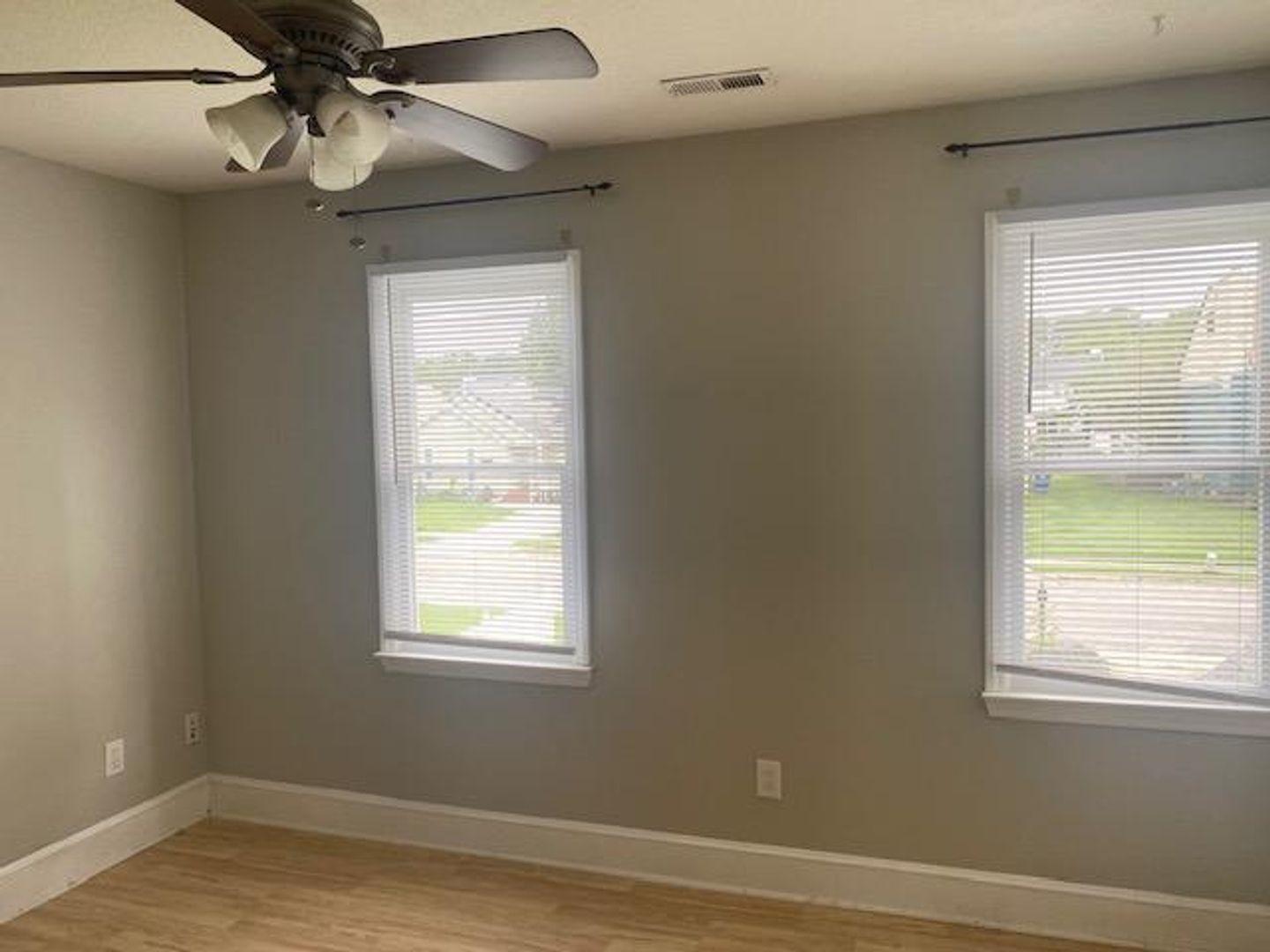 1917 Carthage Circle Raleigh, NC 27604 - Photo 10 of 15 a view of an empty room with wooden floor and a window