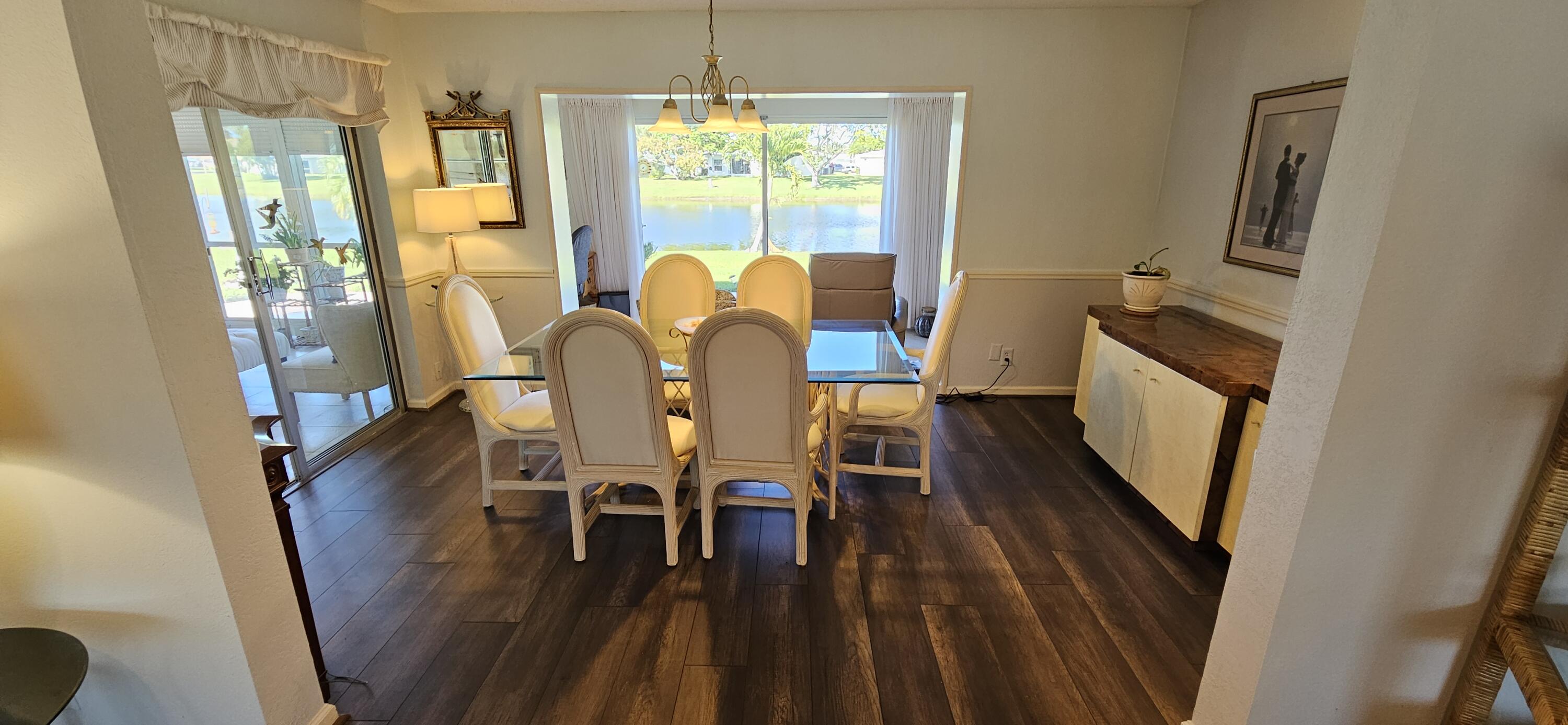 5213 Michael Drive West Palm Beach, FL 33417 - Photo 14 of 47 a view of a dining room with furniture window and wooden floor