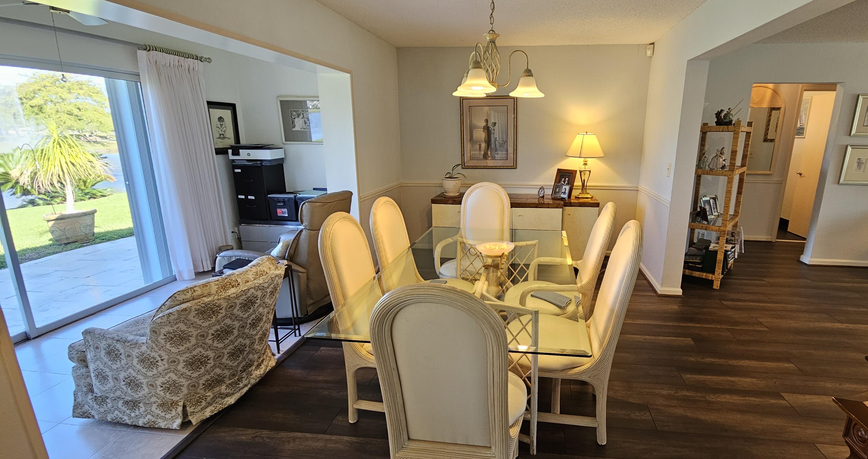 5213 Michael Drive West Palm Beach, FL 33417 - Photo 15 of 47 a view of a dining room with furniture and a chandelier