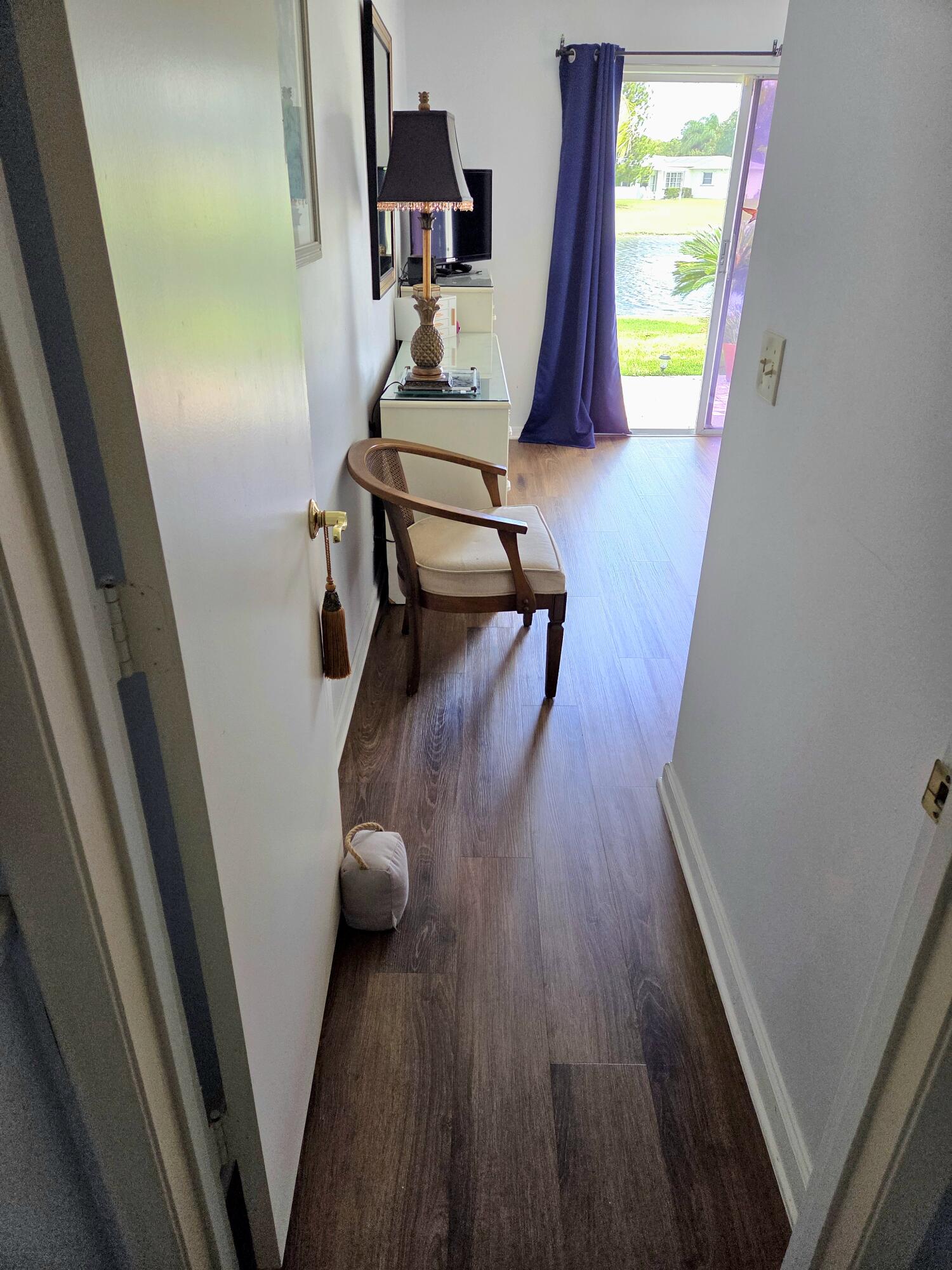 5213 Michael Drive West Palm Beach, FL 33417 - Photo 18 of 47 a view of a hallway with wooden floor and stairs