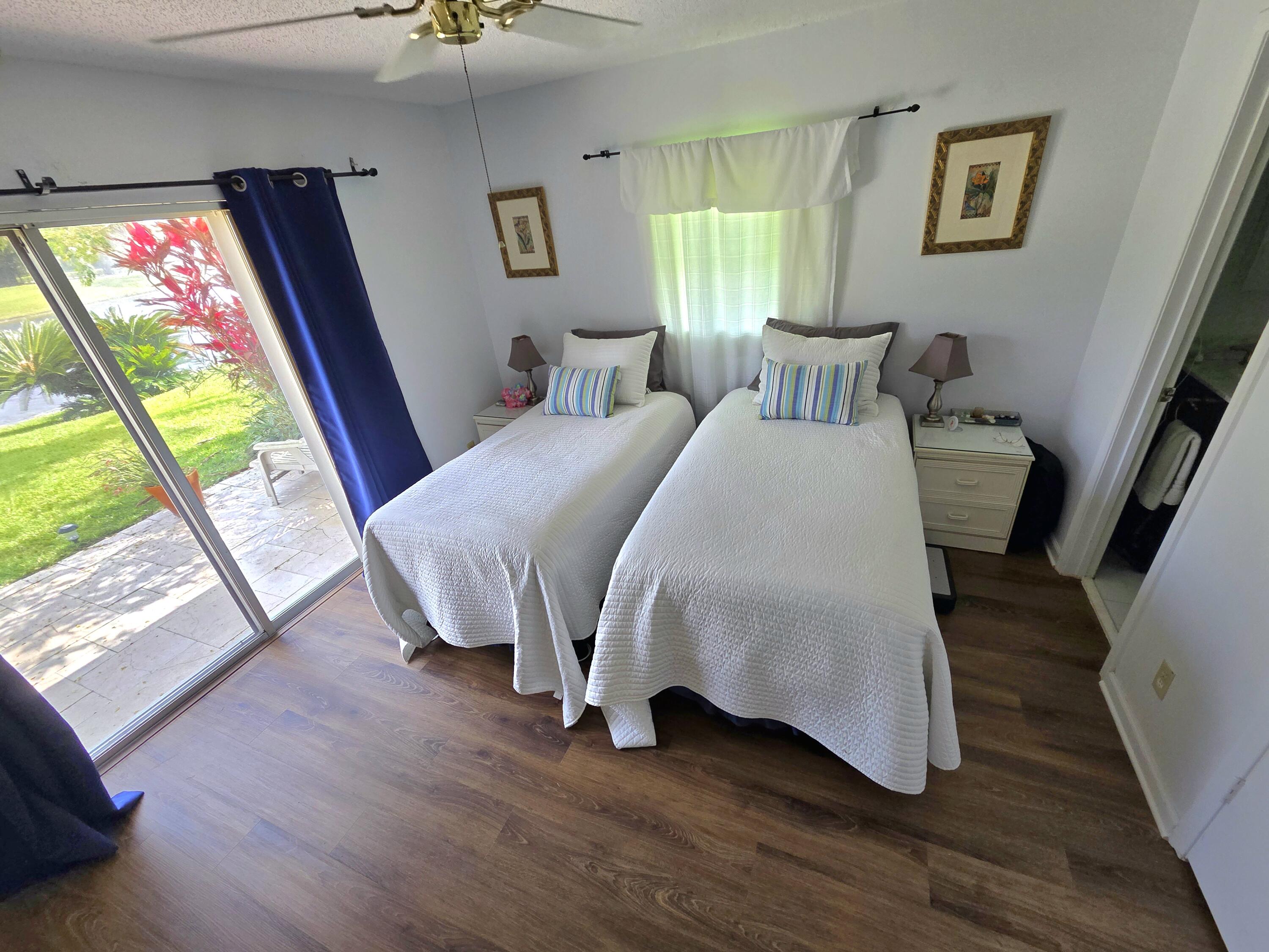 5213 Michael Drive West Palm Beach, FL 33417 - Photo 19 of 47 a bedroom with a bed and a large window