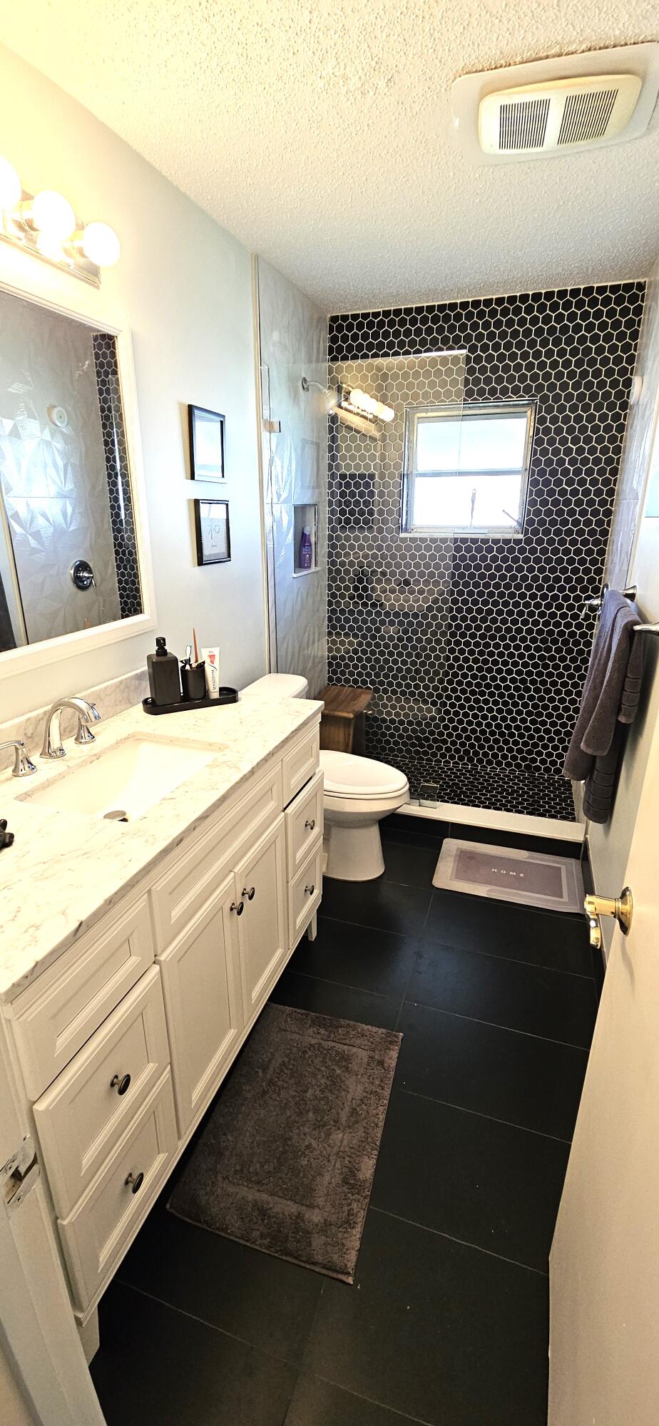 5213 Michael Drive West Palm Beach, FL 33417 - Photo 24 of 47 a bathroom with a sink a toilet and mirror