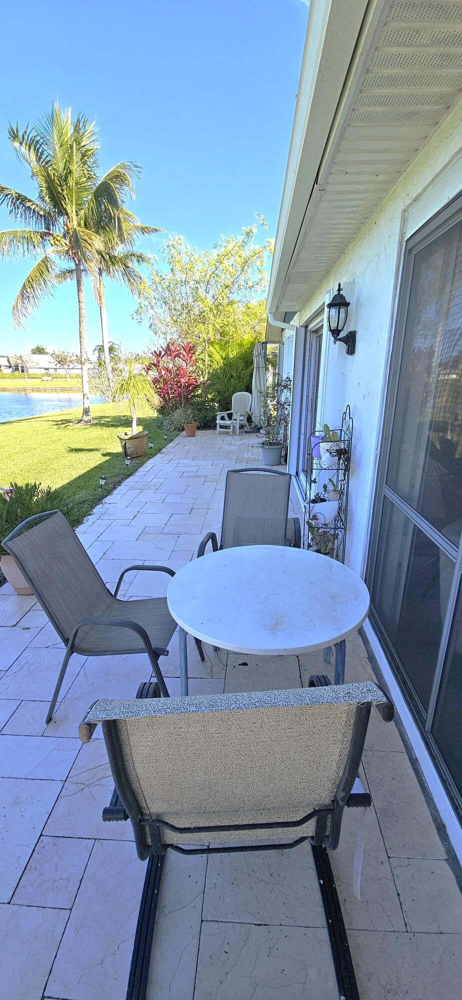 5213 Michael Drive West Palm Beach, FL 33417 - Photo 28 of 47 a view of a swimming pool with a lawn chairs and a yard