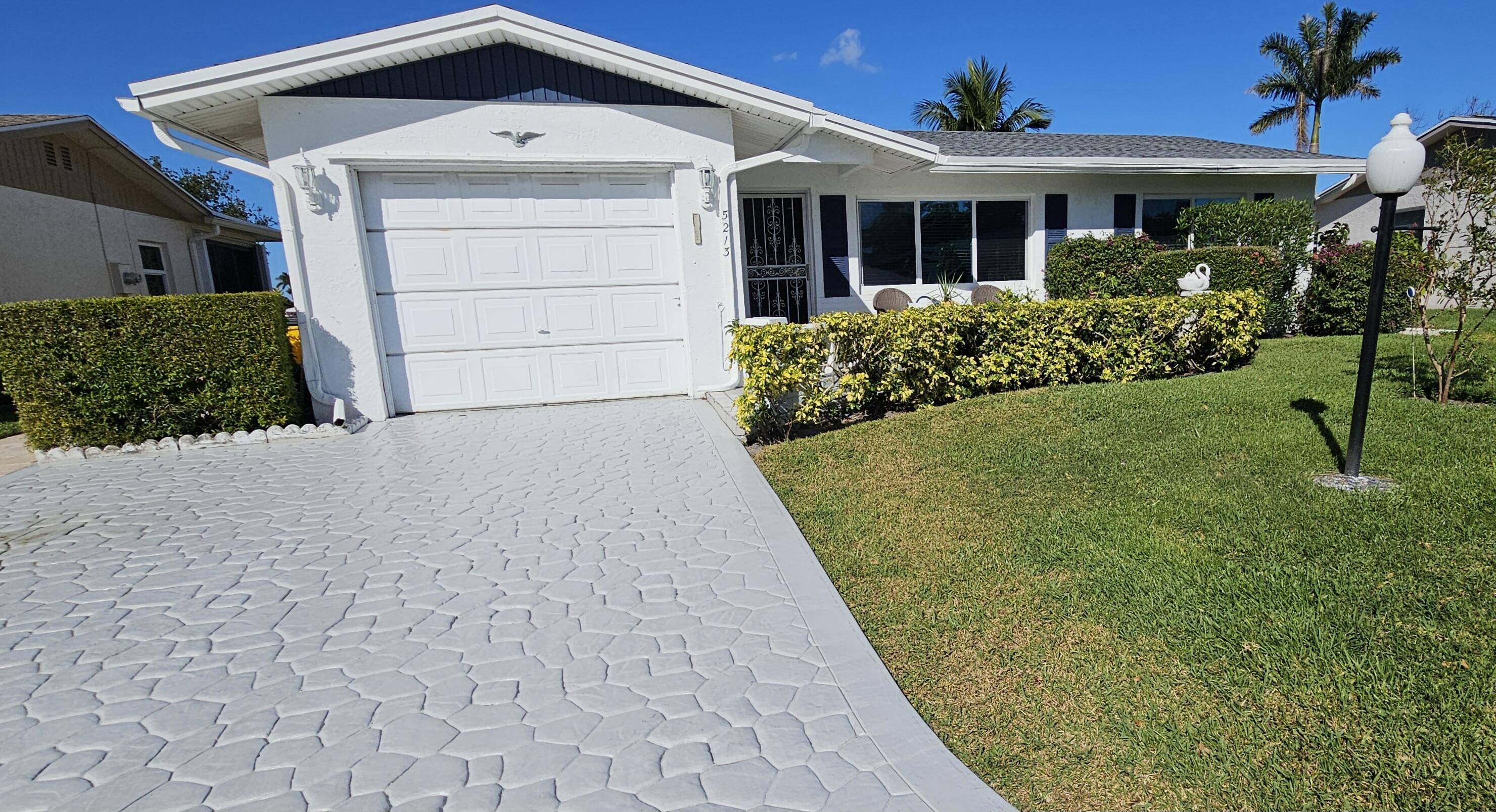 5213 Michael Drive West Palm Beach, FL 33417 - Photo 4 of 47 a front view of a house with a yard