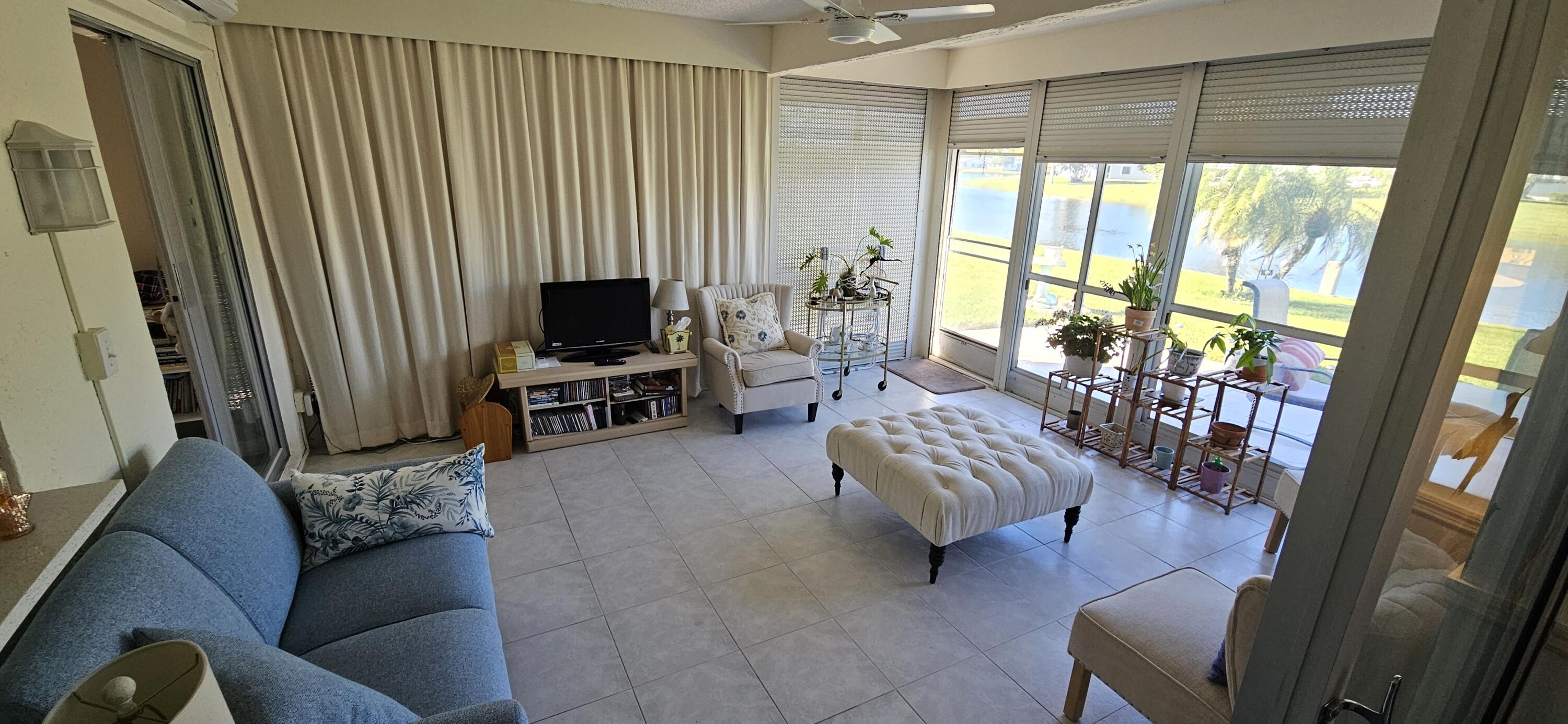 5213 Michael Drive West Palm Beach, FL 33417 - Photo 8 of 47 a living room with furniture and a flat screen tv