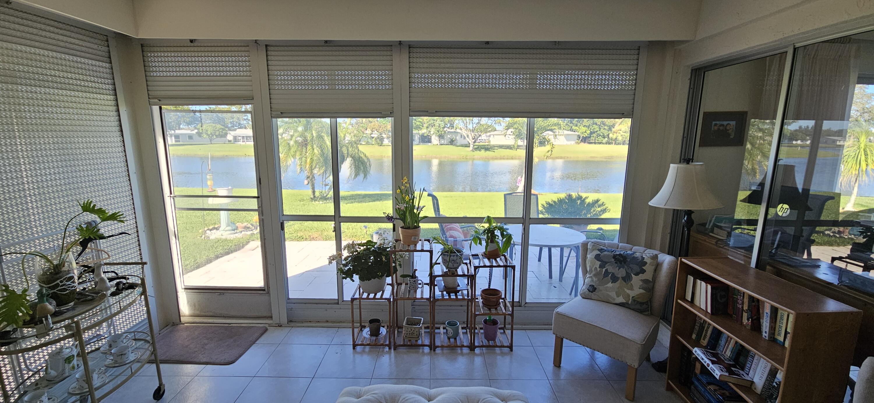 5213 Michael Drive West Palm Beach, FL 33417 - Photo 9 of 47 a living room with furniture and a large window with outer view