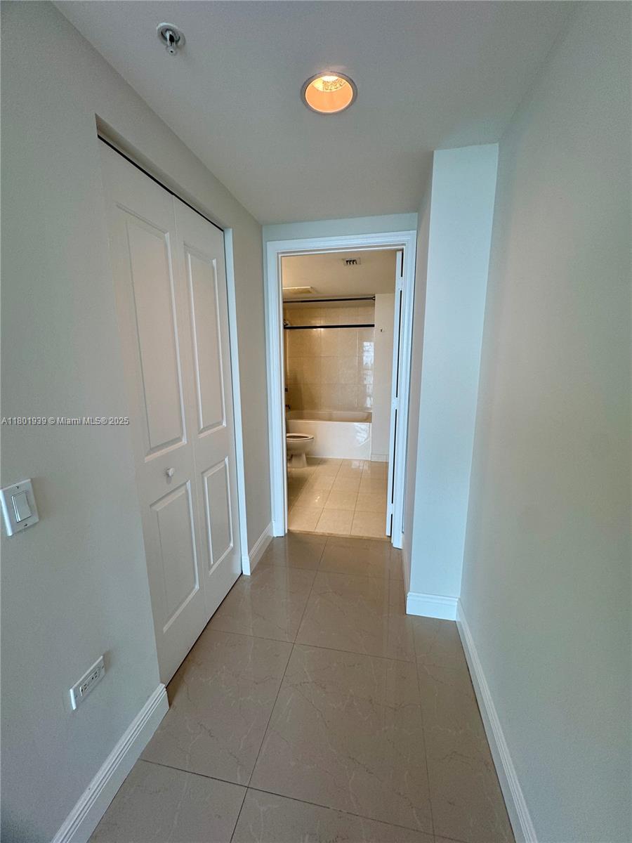 Edgewater Miami, FL 33137 - Photo 11 of 31 a view of a room with an empty space and wooden floor