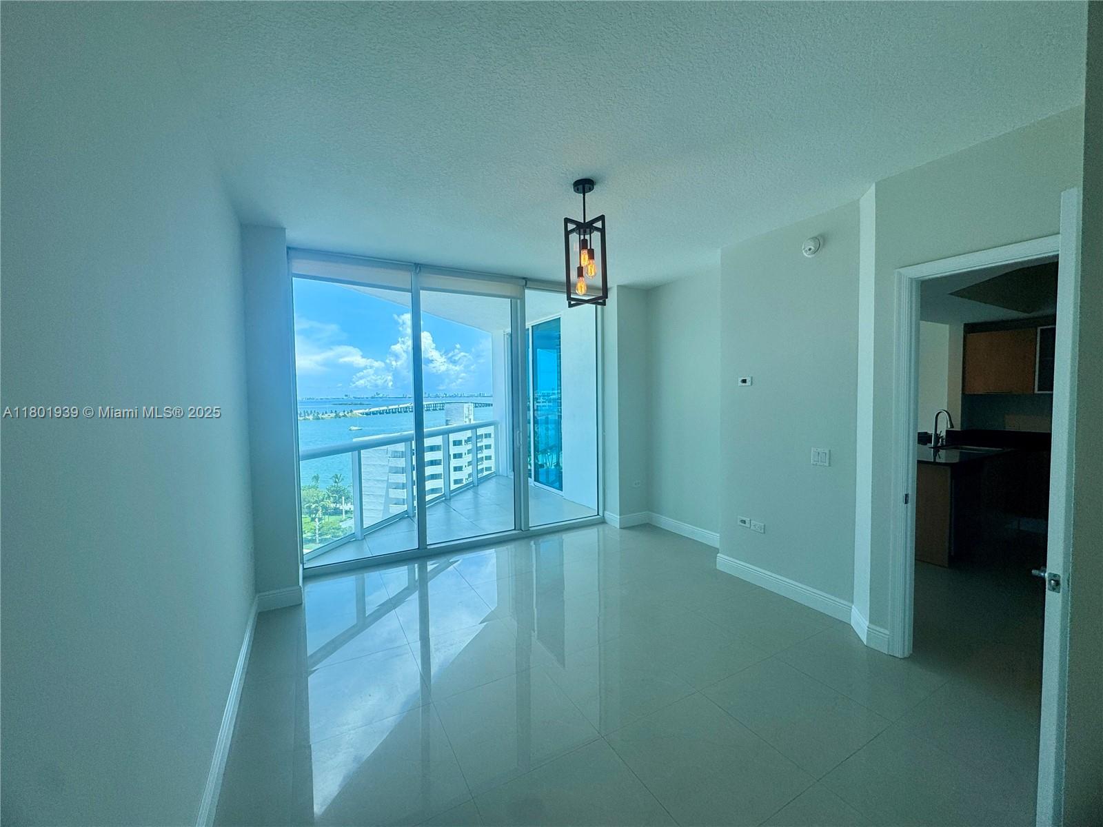 Edgewater Miami, FL 33137 - Photo 14 of 31 a view of an empty room with glass door