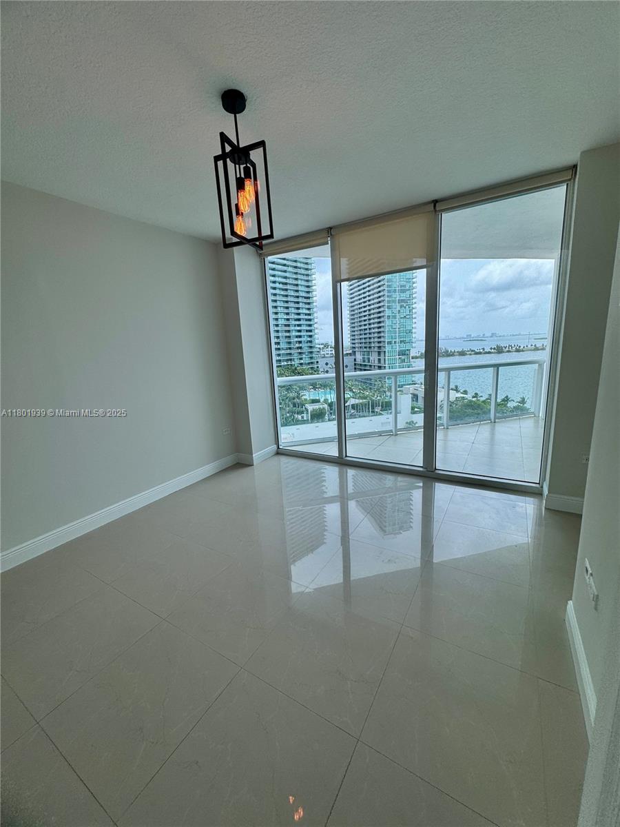 Edgewater Miami, FL 33137 - Photo 15 of 31 wooden floor in an empty room with a window
