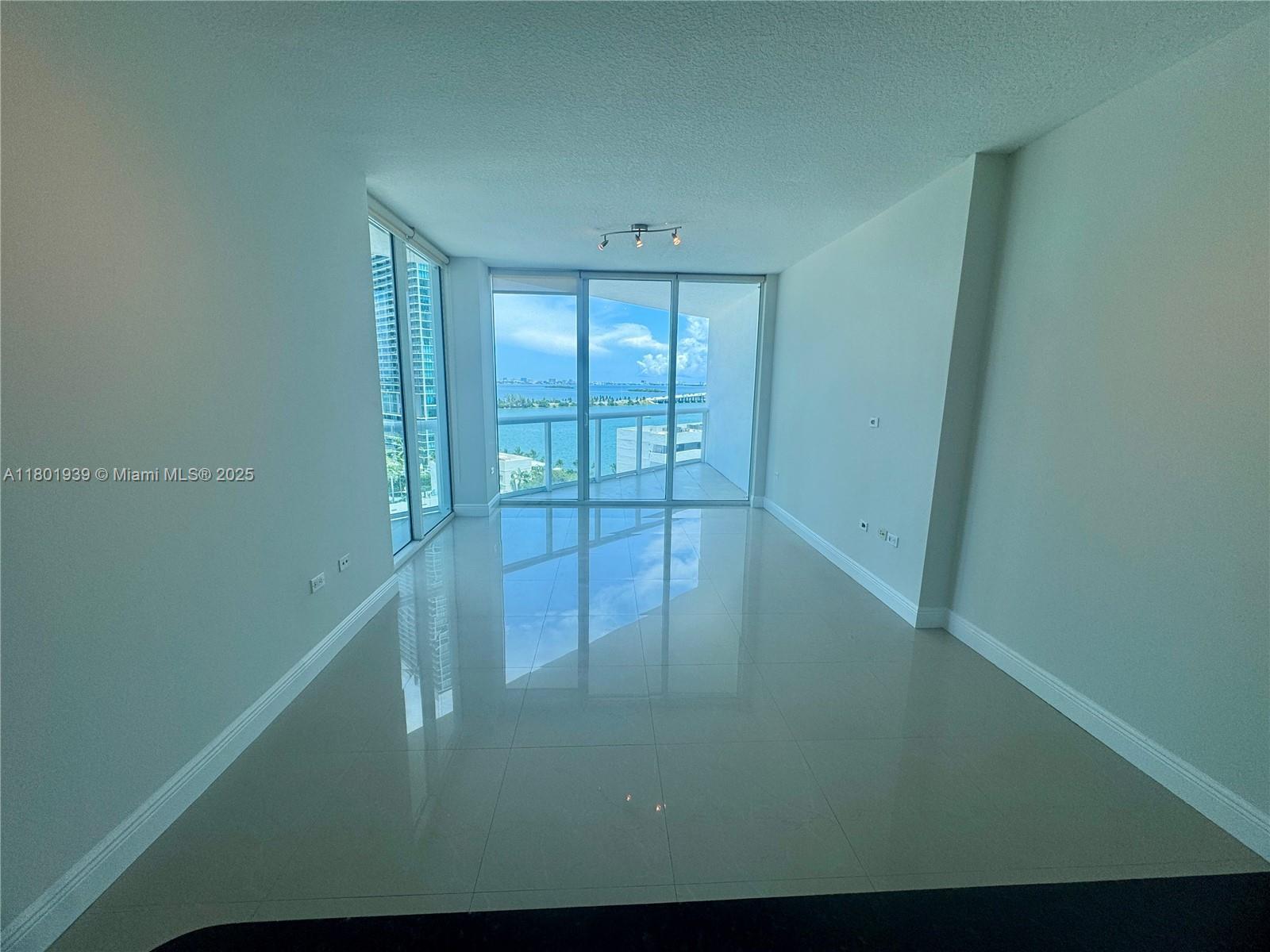 Edgewater Miami, FL 33137 - Photo 4 of 31 a view of empty room with floor to ceiling window