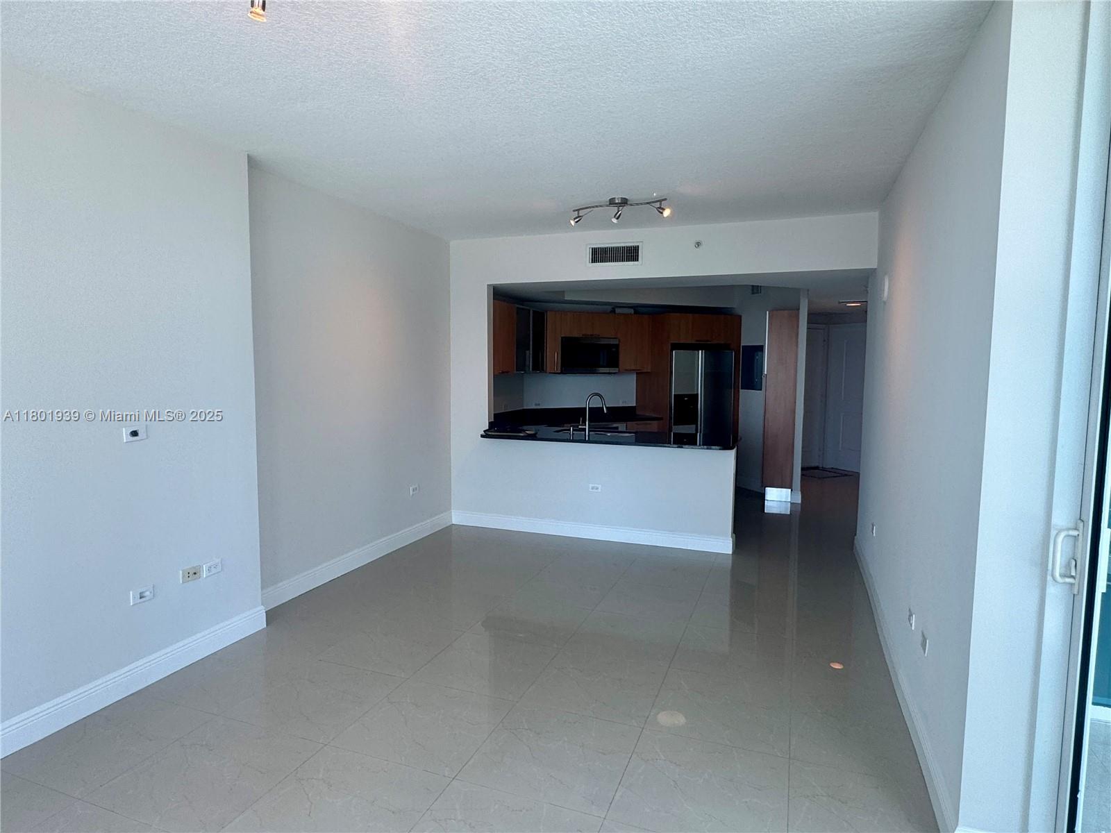 Edgewater Miami, FL 33137 - Photo 5 of 31 a view of an empty room with a fireplace and tv