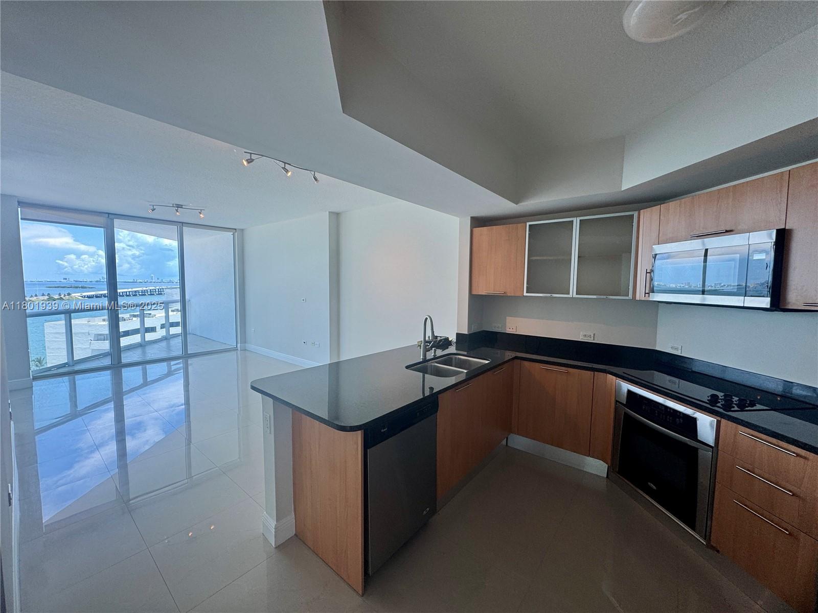 Edgewater Miami, FL 33137 - Photo 7 of 31 a kitchen with stainless steel appliances granite countertop a sink and a stove