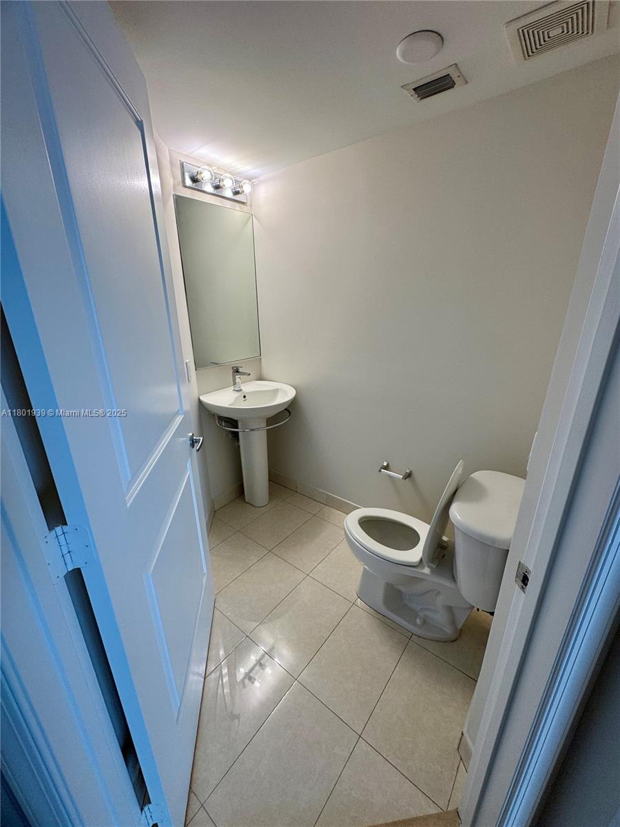 Edgewater Miami, FL 33137 - Photo 10 of 31 a bathroom with a toilet sink and mirror